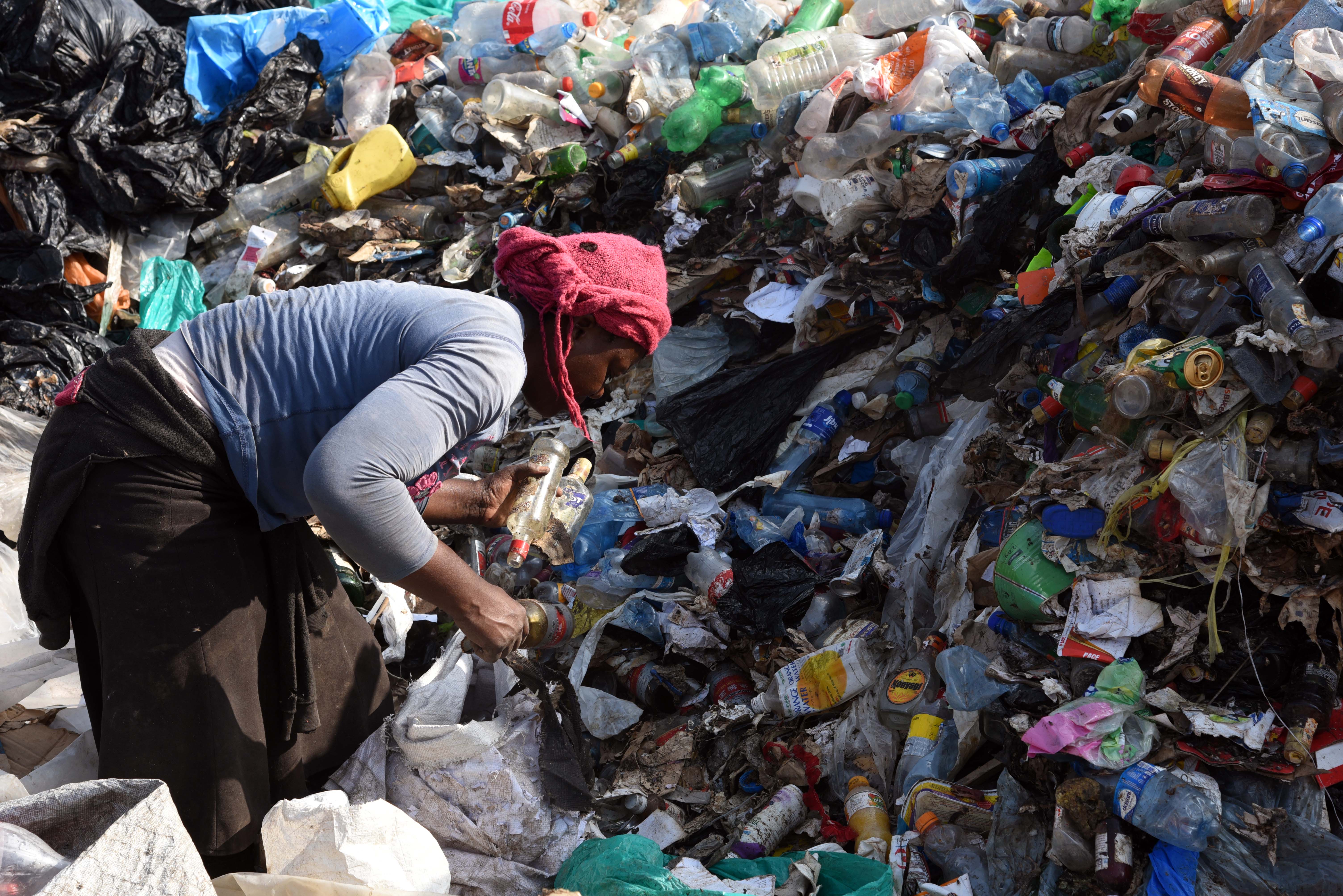 A woman separates plastic bottles at the Dandora landfill on the outskirts of Nairobi, Kenya [Al Jazeera: Courtesy of Pauline Mpungu]