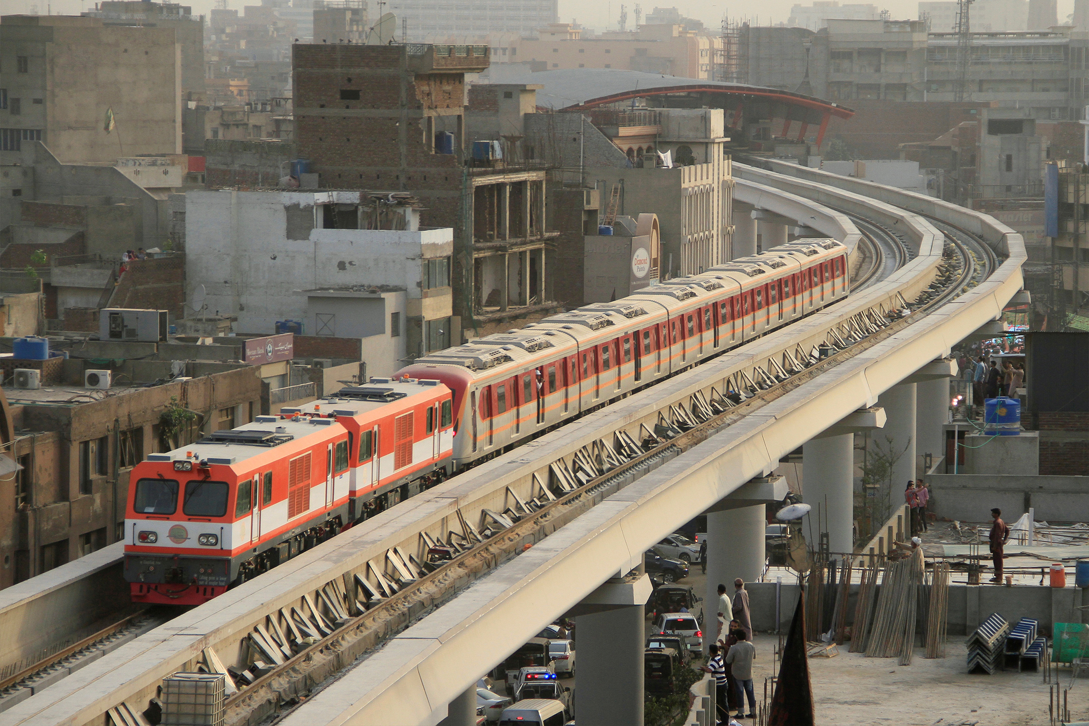The Orange Line Metro Train on its first test-run, travels along a track in a neighbourhood in Lahore, Pakistan on May 16, 2018 [File:Mohsin Raza/Reuters]