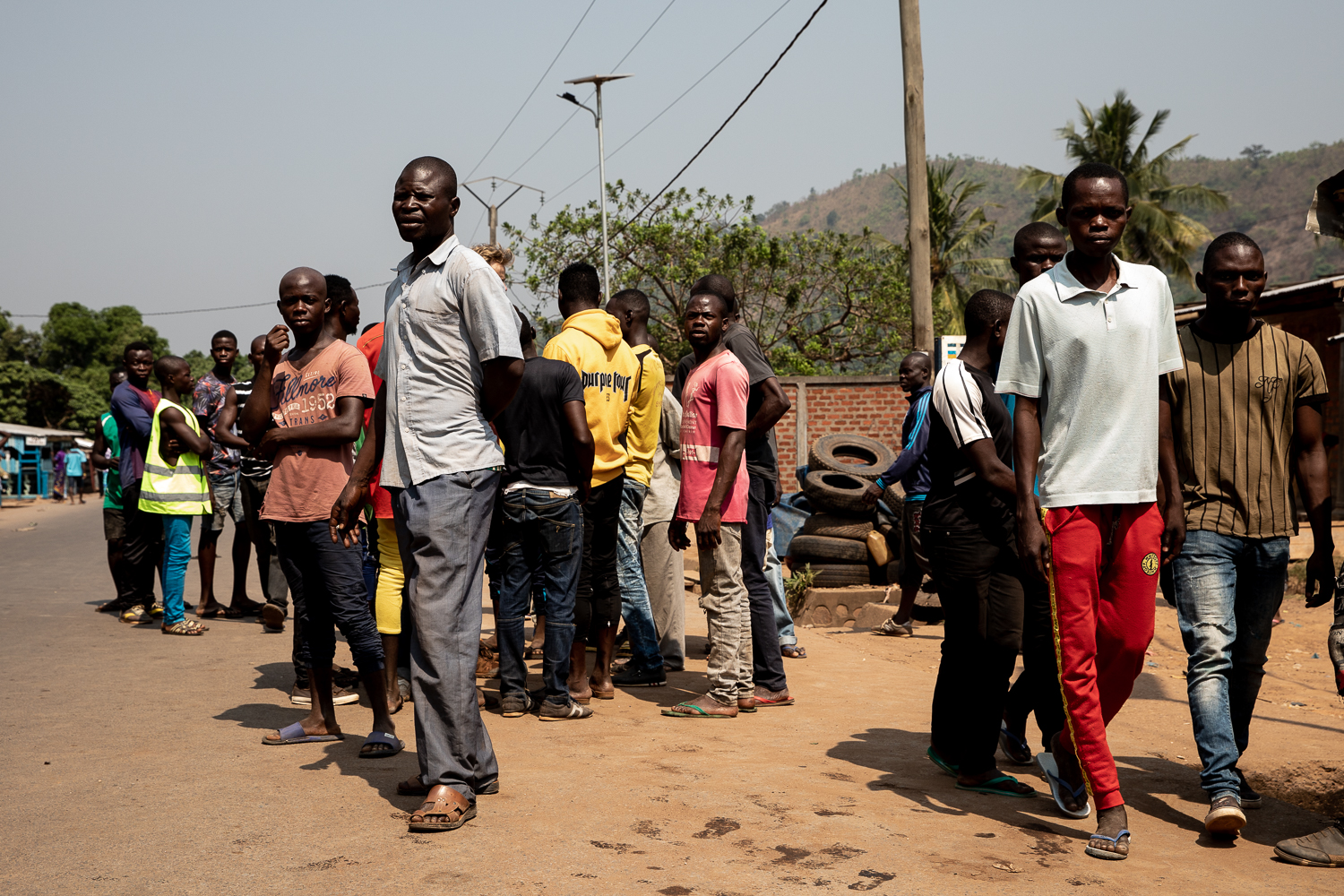 During a lull in the fighting, people come to collect information and assess the situation. Some fled towards the city centre, but many stayed hidden in their homes during the fighting. [Adrienne Suprenant/Al Jazeera]