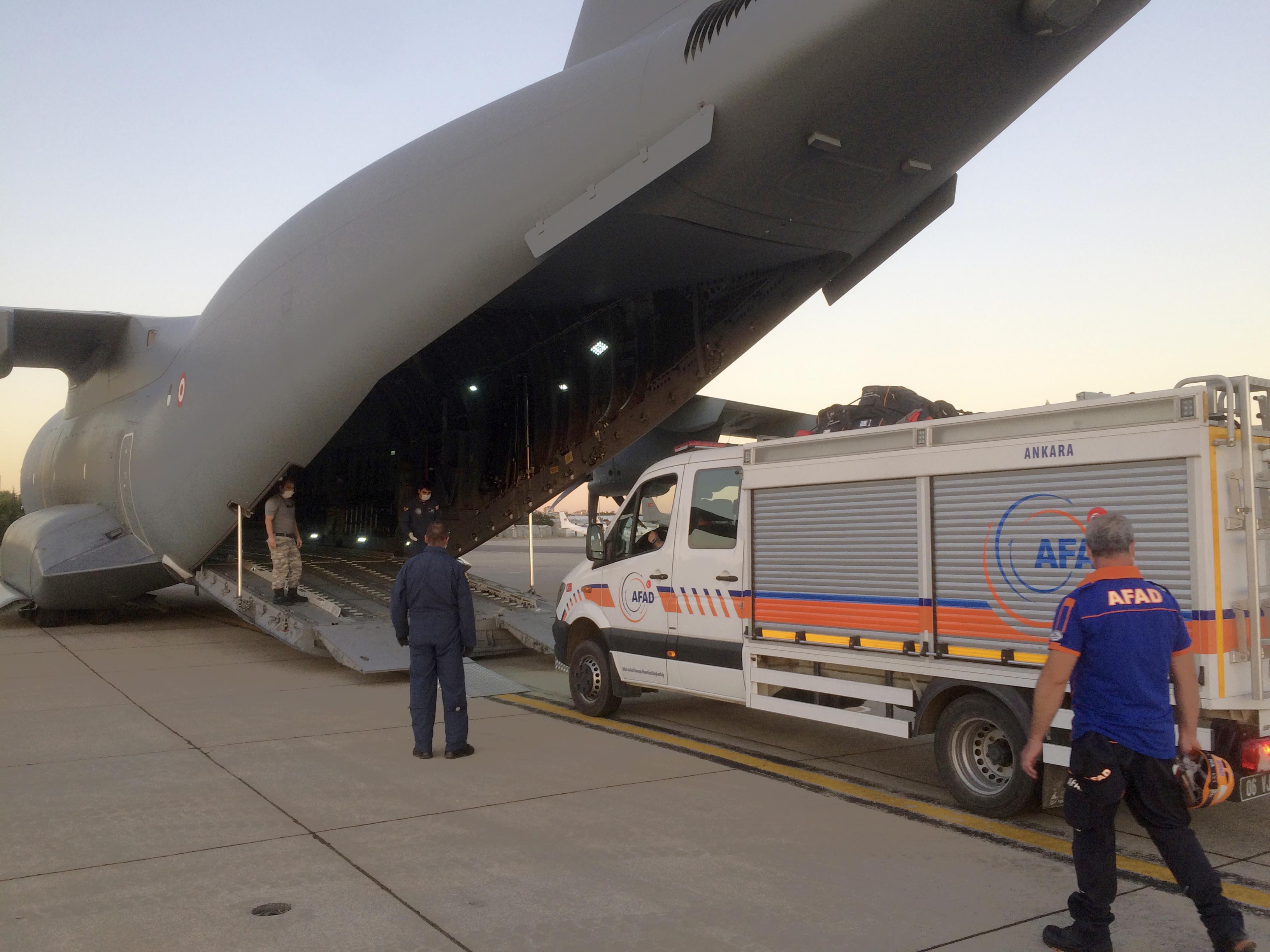 Rescue workers load goods to be sent to Lebanon into a cargo plane at a military airport near Ankara, Turkey on August 5, 2020 [Turkish Defense Ministry via AP]