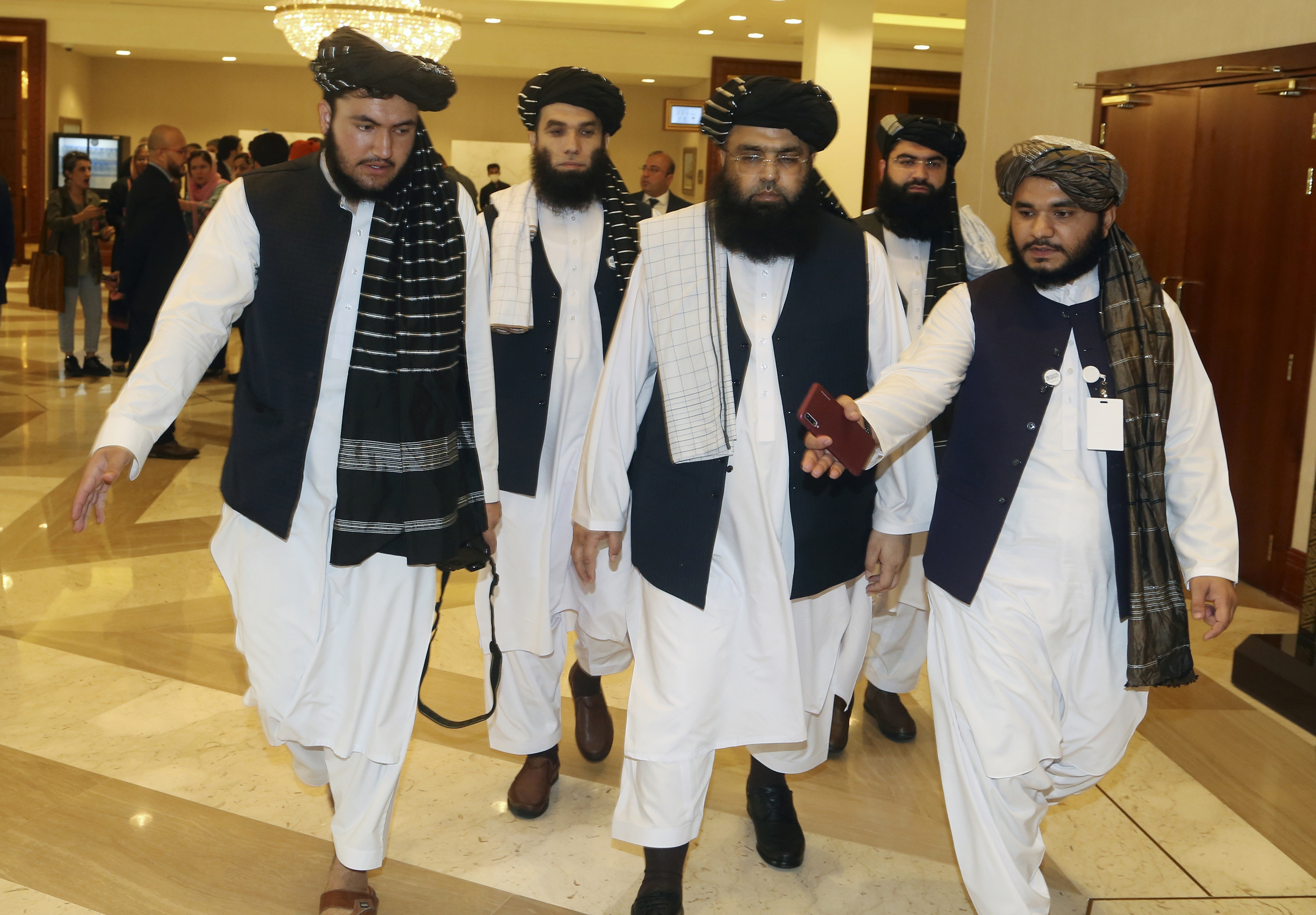 Members of the Taliban delegation head to attend the opening session of the peace talks with the Afghan government in Doha, Qatar, September 12, 2020 [File: Hussein Sayed/AP Photo]