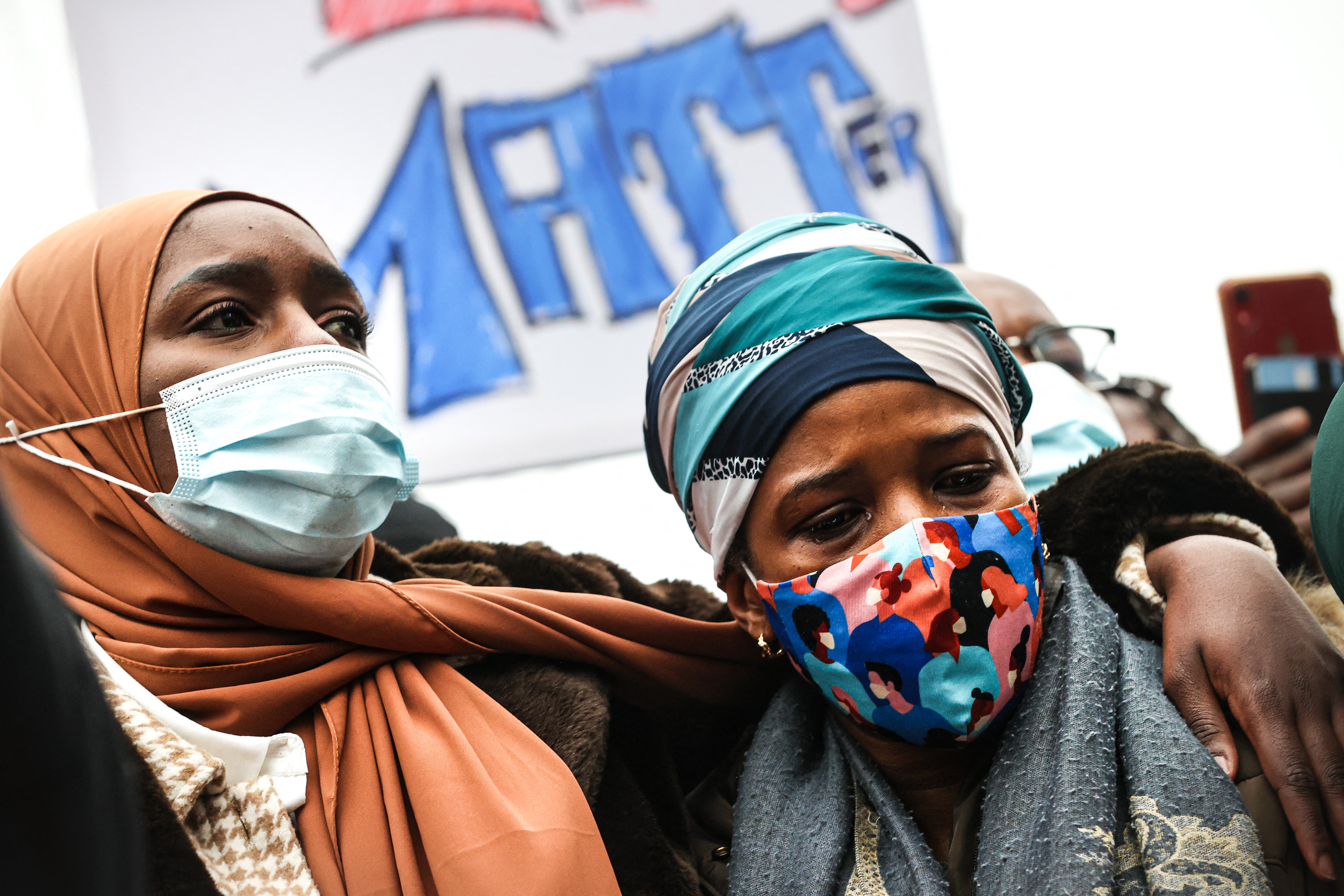 Ibrahima's mother takes part in a demonstration on January 13, 2021 outside the police station in Brussels, where her son was held before he was rushed to hospital and died on January 9, 2021 [File: AFP/Virginie Lefour]