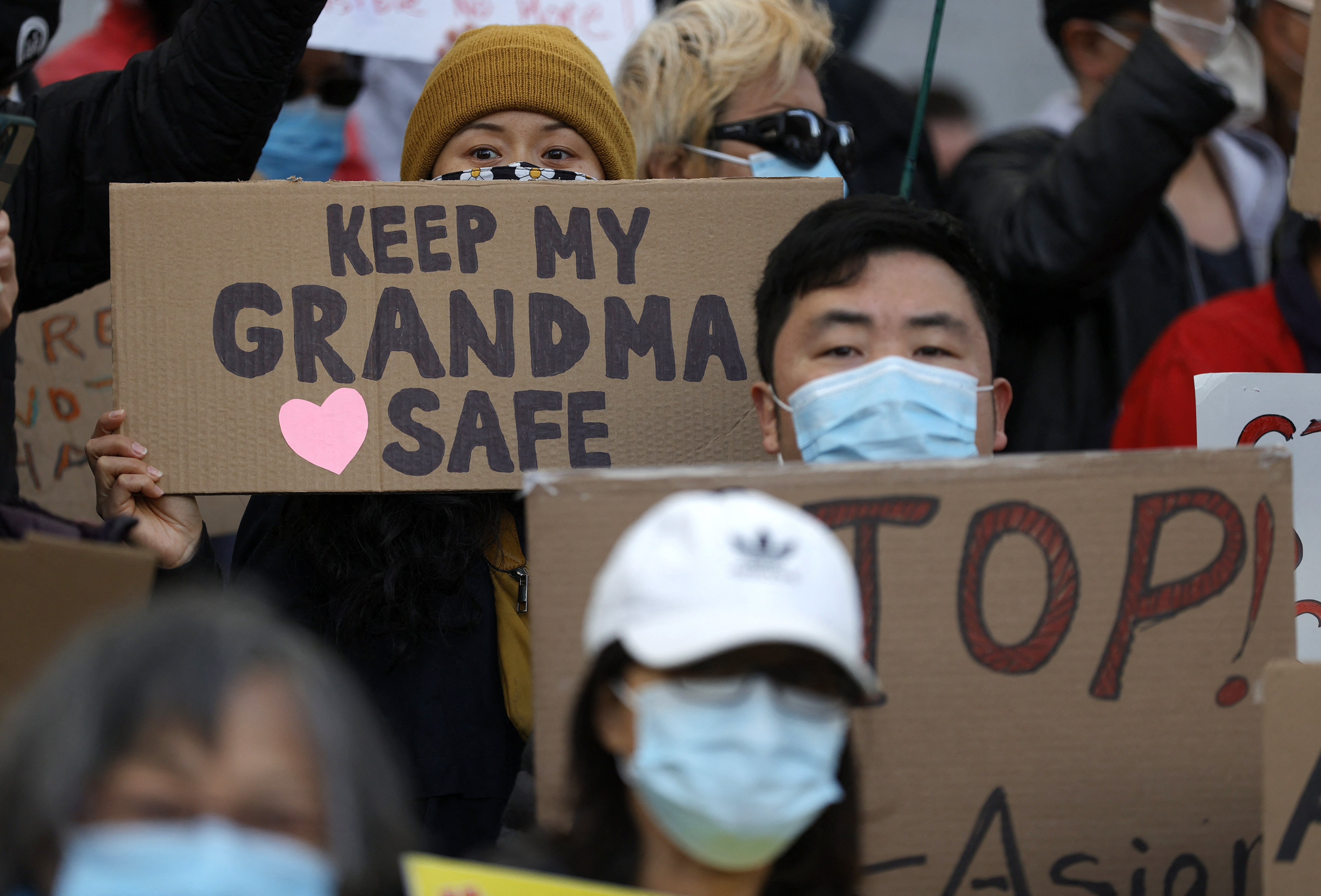 People hold signs during a rally in solidarity with Asian hate crime victims outside of the San Francisco Hall of Justice on March 22, 2021 [Justin Sullivan/Getty Images via AFP]