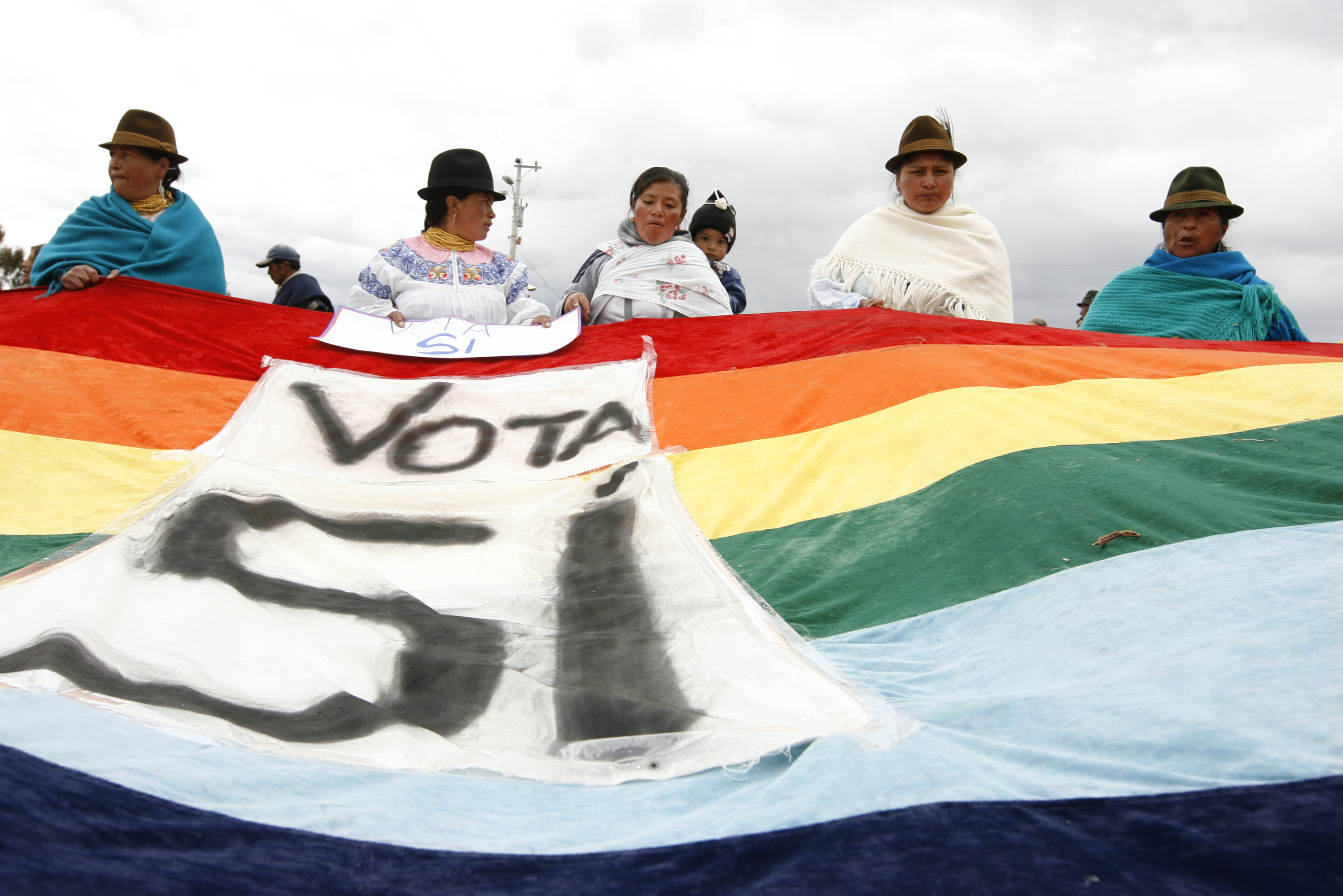 Indigenous people in Ecuador hold a banner which reads, ‘Vote Yes’, during a rally in support of a referendum to approve the country’s 2008 constitution