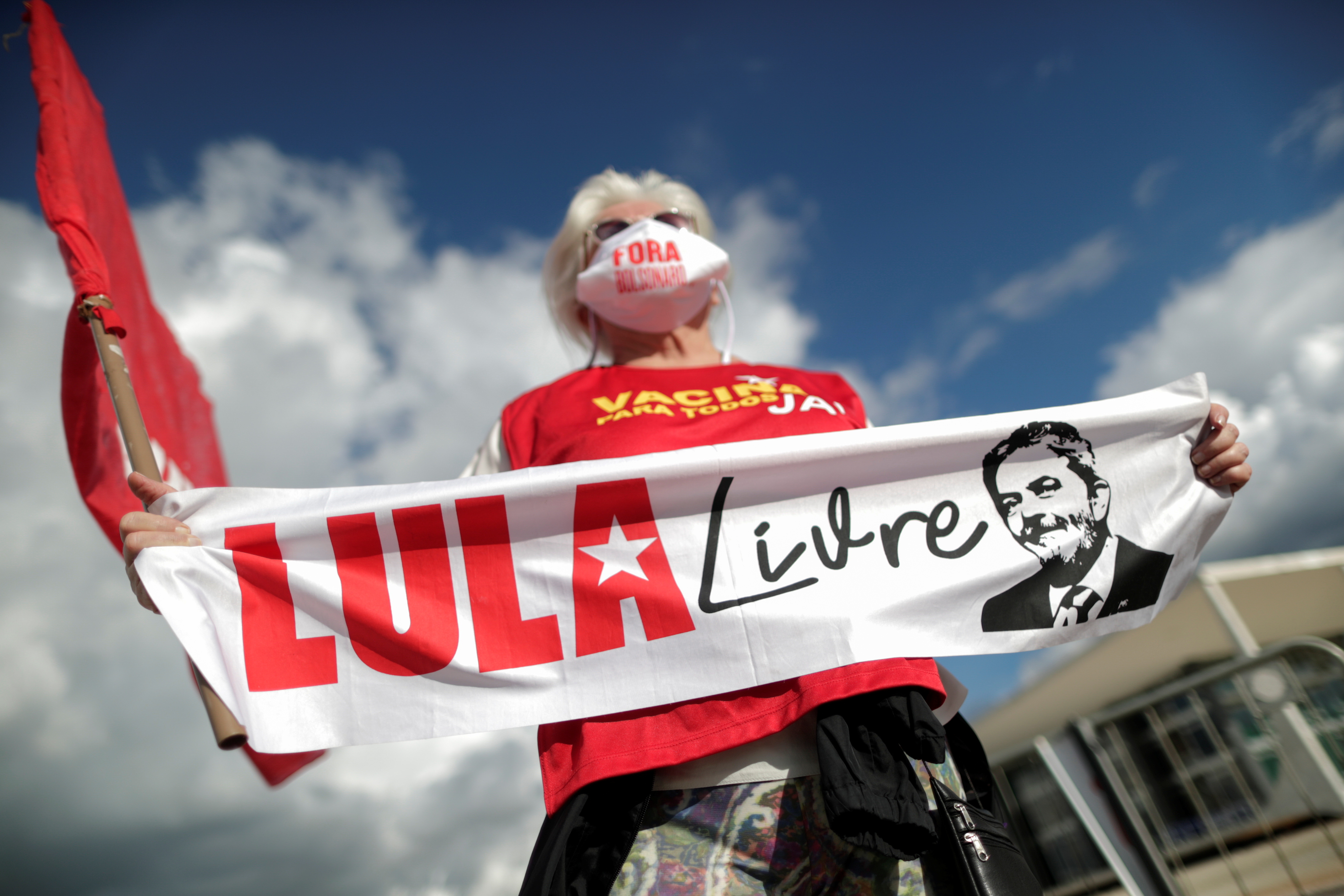 A supporter of Brazil's former President Luiz Inacio Lula da Silva holds a sign reading 'Lula free' during a protest in front of the Supreme Court in Brasilia, Brazil, on March 9 [Ueslei Marcelino/Reuters]