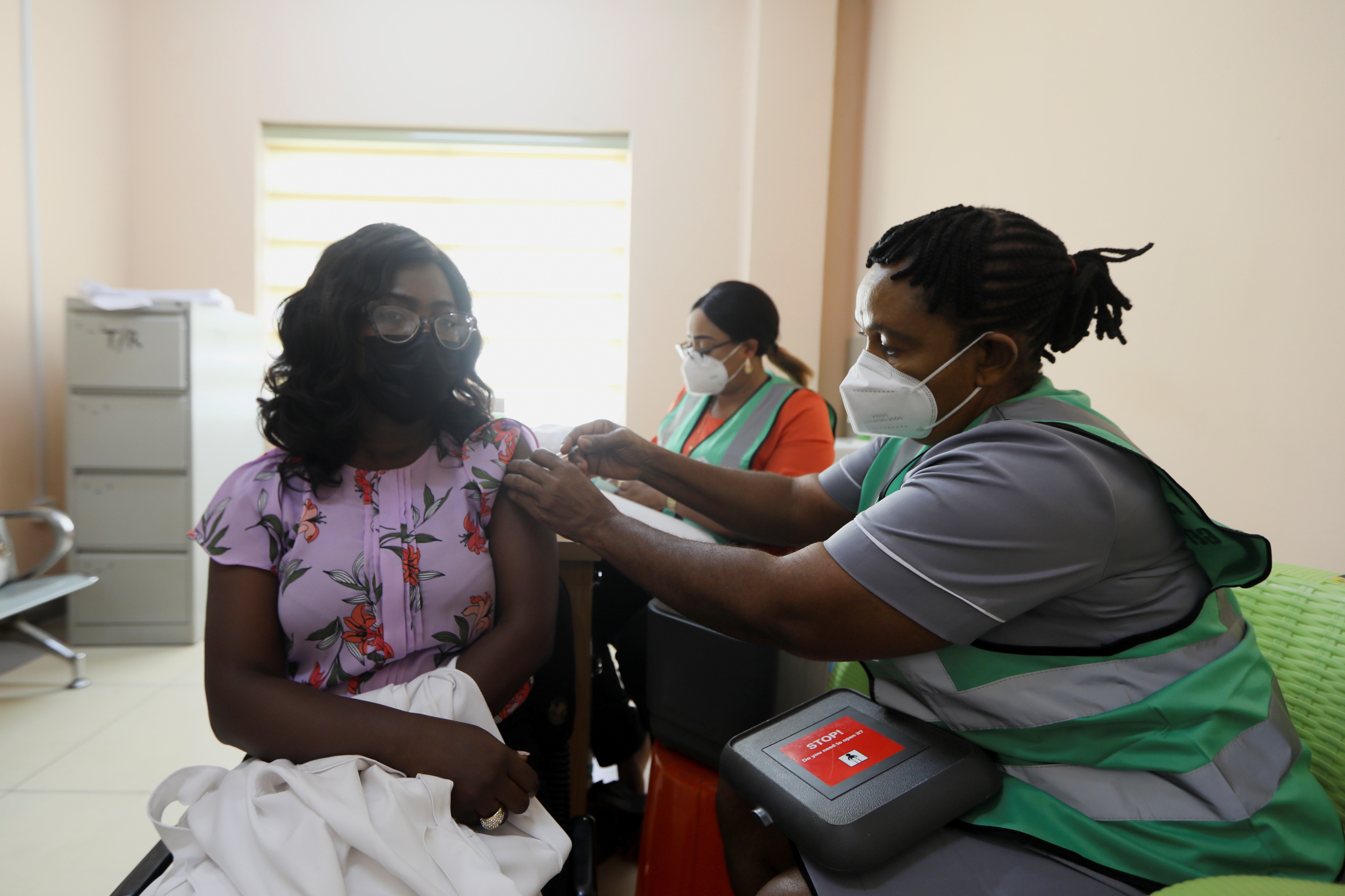 A person receives a dose of the Oxford-AstraZeneca coronavirus disease (COVID-19) vaccine at the National Hospital in Abuja, Nigeria, on March 5, 2021 [Afolabi Sotunde/Reuters]