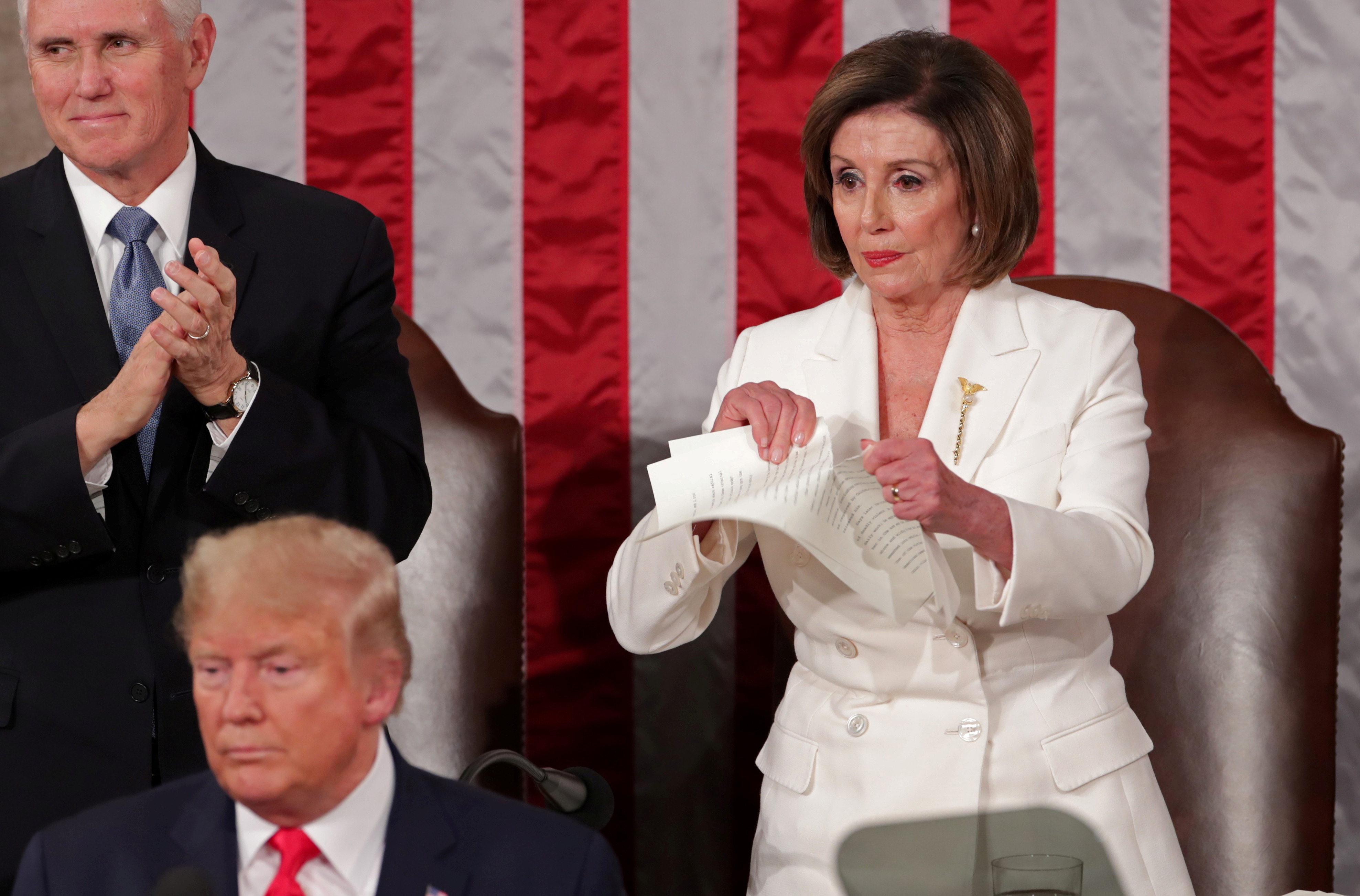 Speaker of the House Nancy Pelosi (D-CA) rips up the speech of US President Donald Trump as she stands behind him.