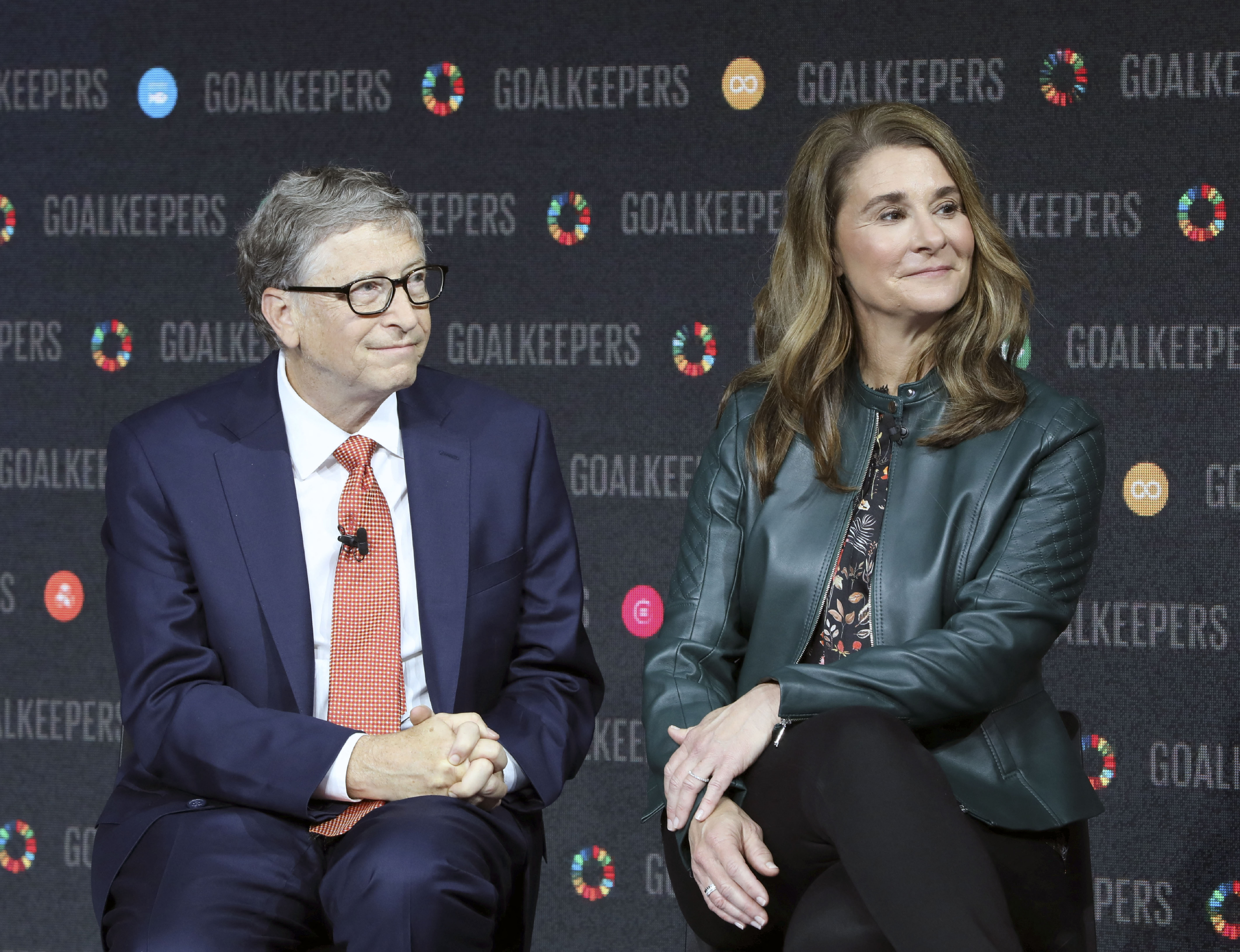Bill and Melinda Gates look to the audience at a conference