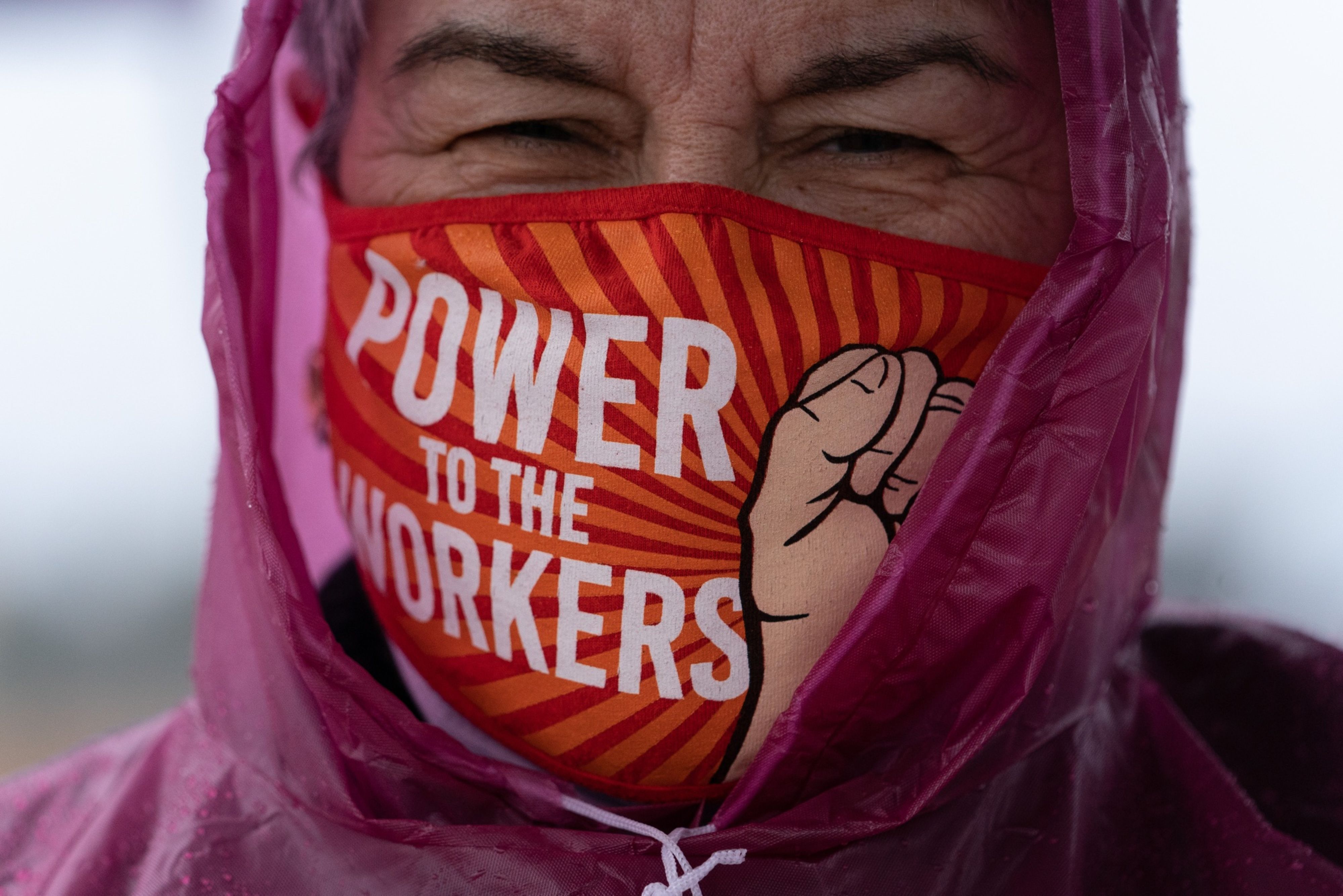 A demonstrator wears a protective mask that reads "Power To The Workers" during a Retail, Wholesale and Department Store Union held protest outside the Amazon Center in Bessemer, Alabama in the US.
