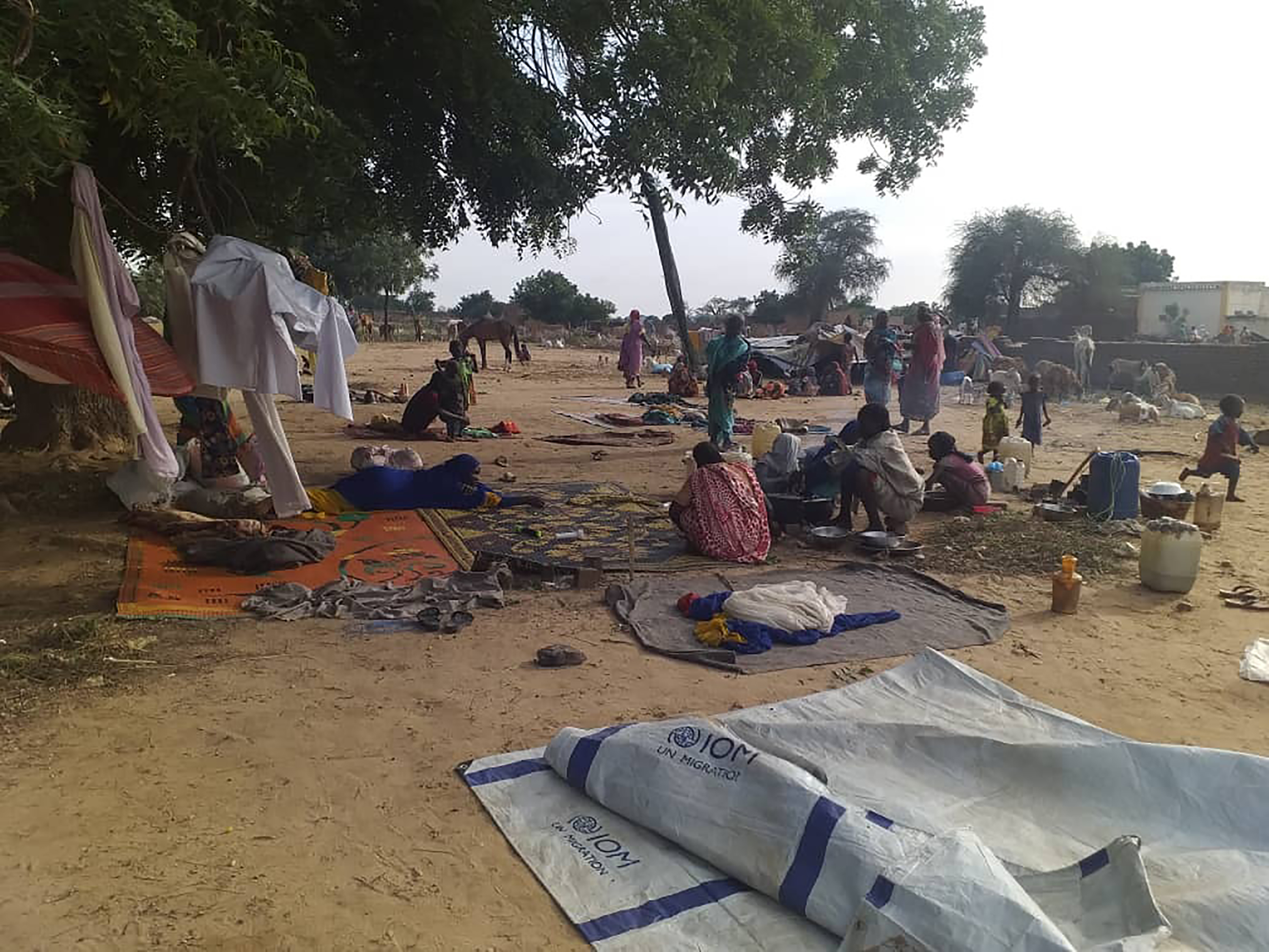 A July 30, 2020 shows residents displaced from violent attacks in squat on blankets and in hastily made tents in the village of Masteri in West Darfur, Sudan [File: Mustafa Younes/AP Photo]