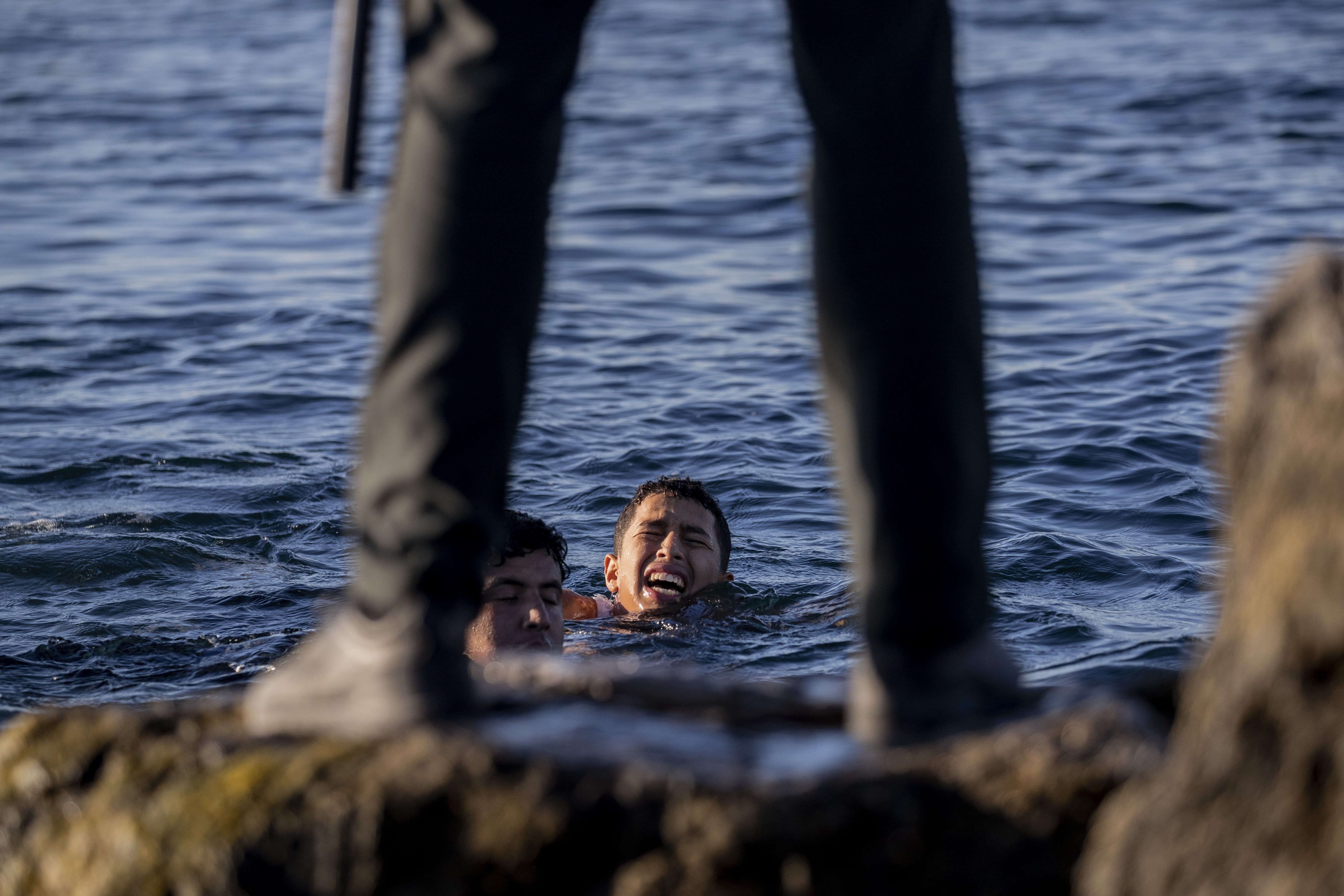 A Spanish civil guard wait for migrants to arrive at the Spanish enclave of Ceuta, near the border of Morocco and Spain, Wednesday, May 19, 2021. Spanish officials are acknowledging for the first time that the unprecedented migrant crisis has been triggered by an angry Rabat at Madrid's decision to provide medical treatment to the militant boss of the Polisario Front. (AP Photo/Bernat Armangue)