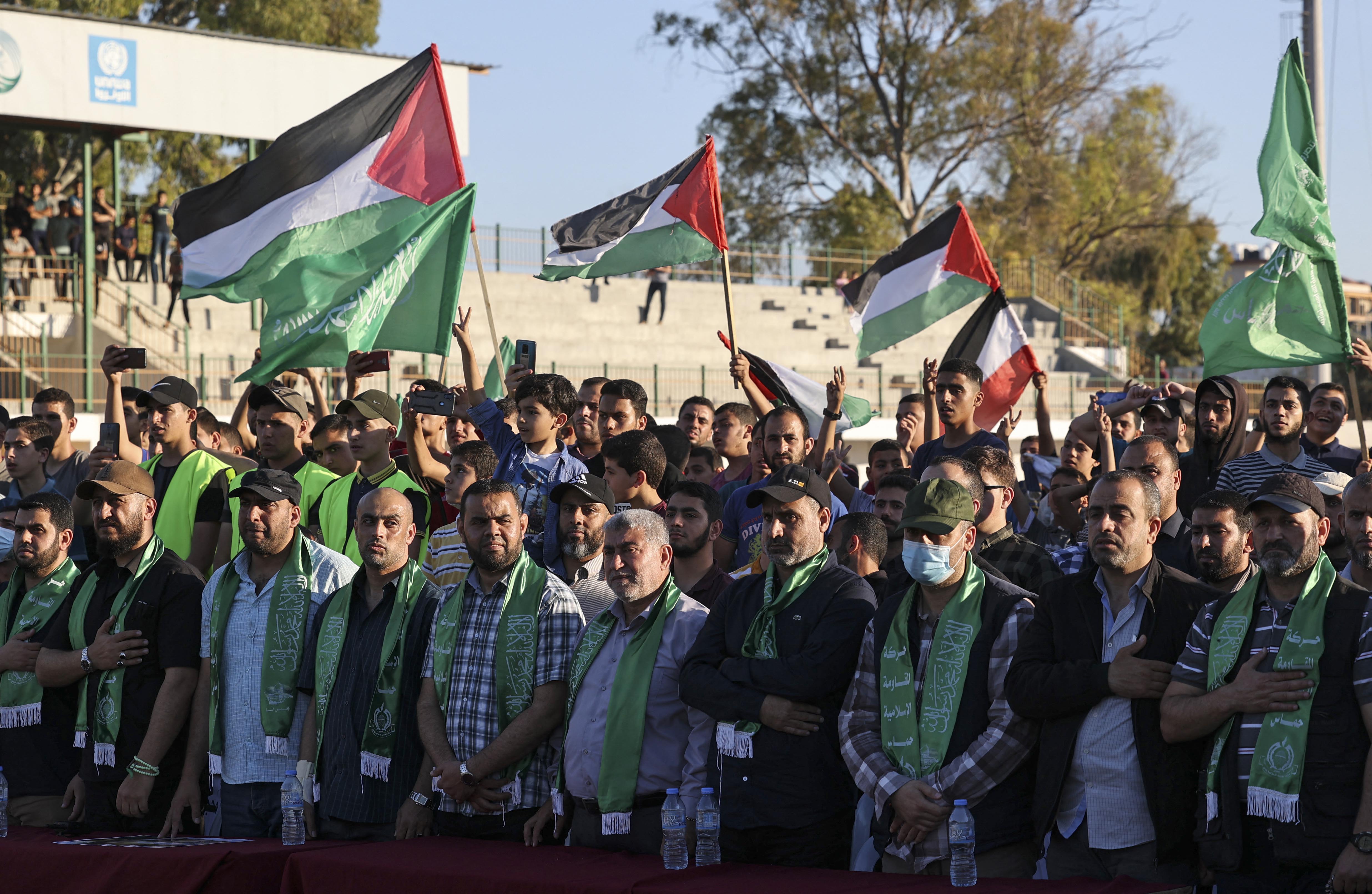 Supporters of Hamas wave flags during a rally in Gaza City on May 24, 2021 [AFP/Mahmud Hams]