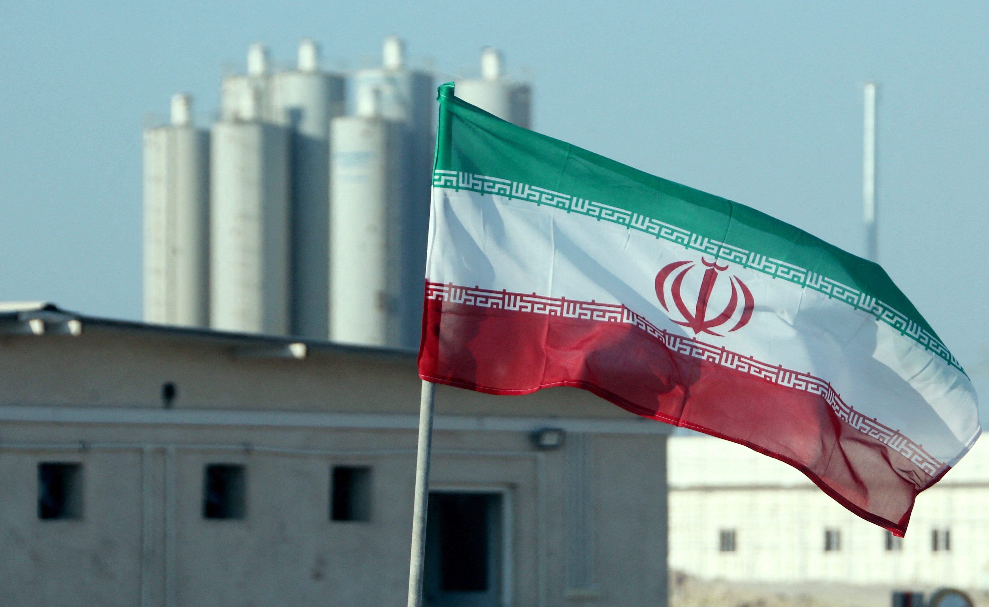 An Iranian flag flying over Iran's Bushehr nuclear power plant.