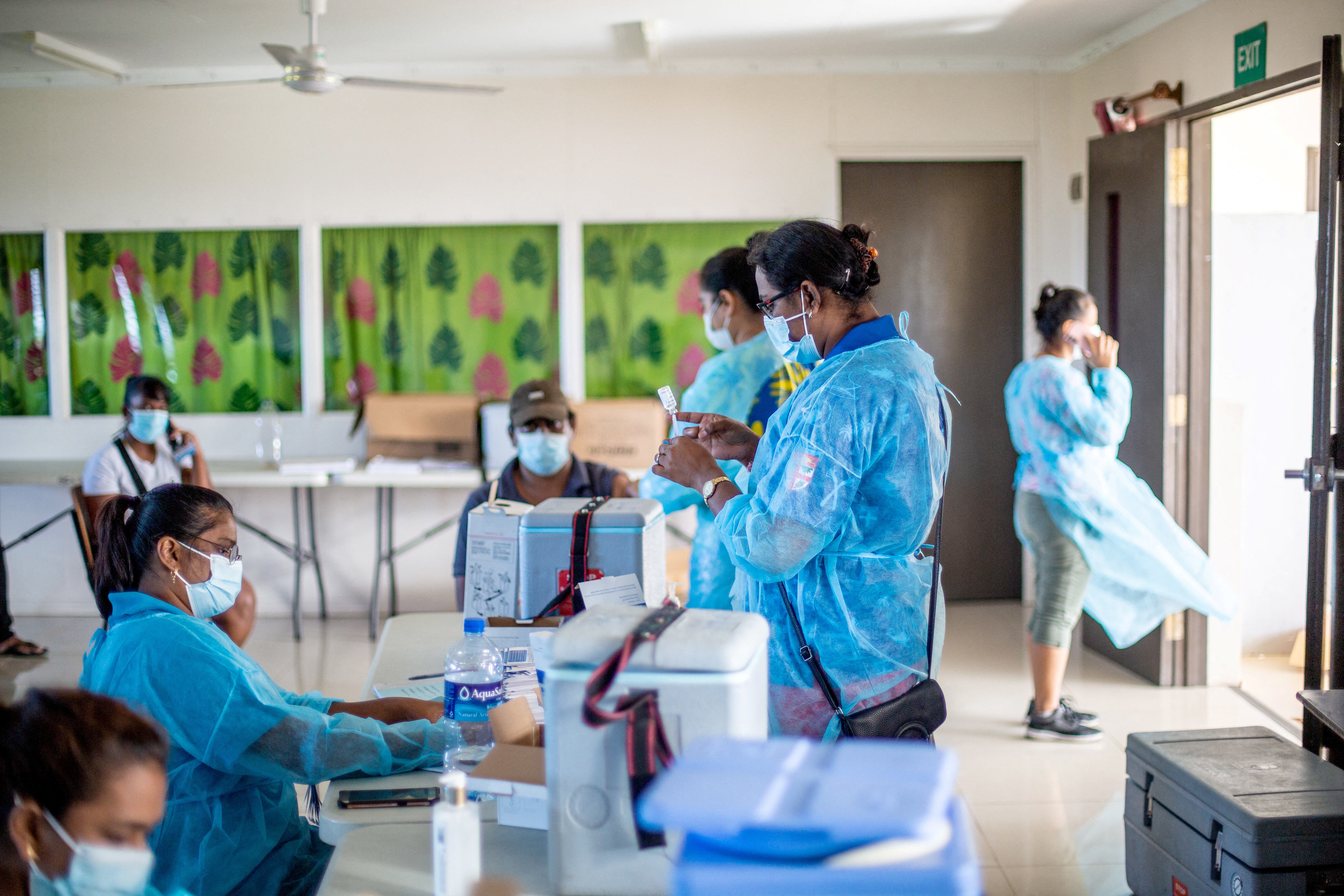 This picture taken on June 11, 2021 shows health workers preparing to administer the Covid-19 vaccination in Suva.