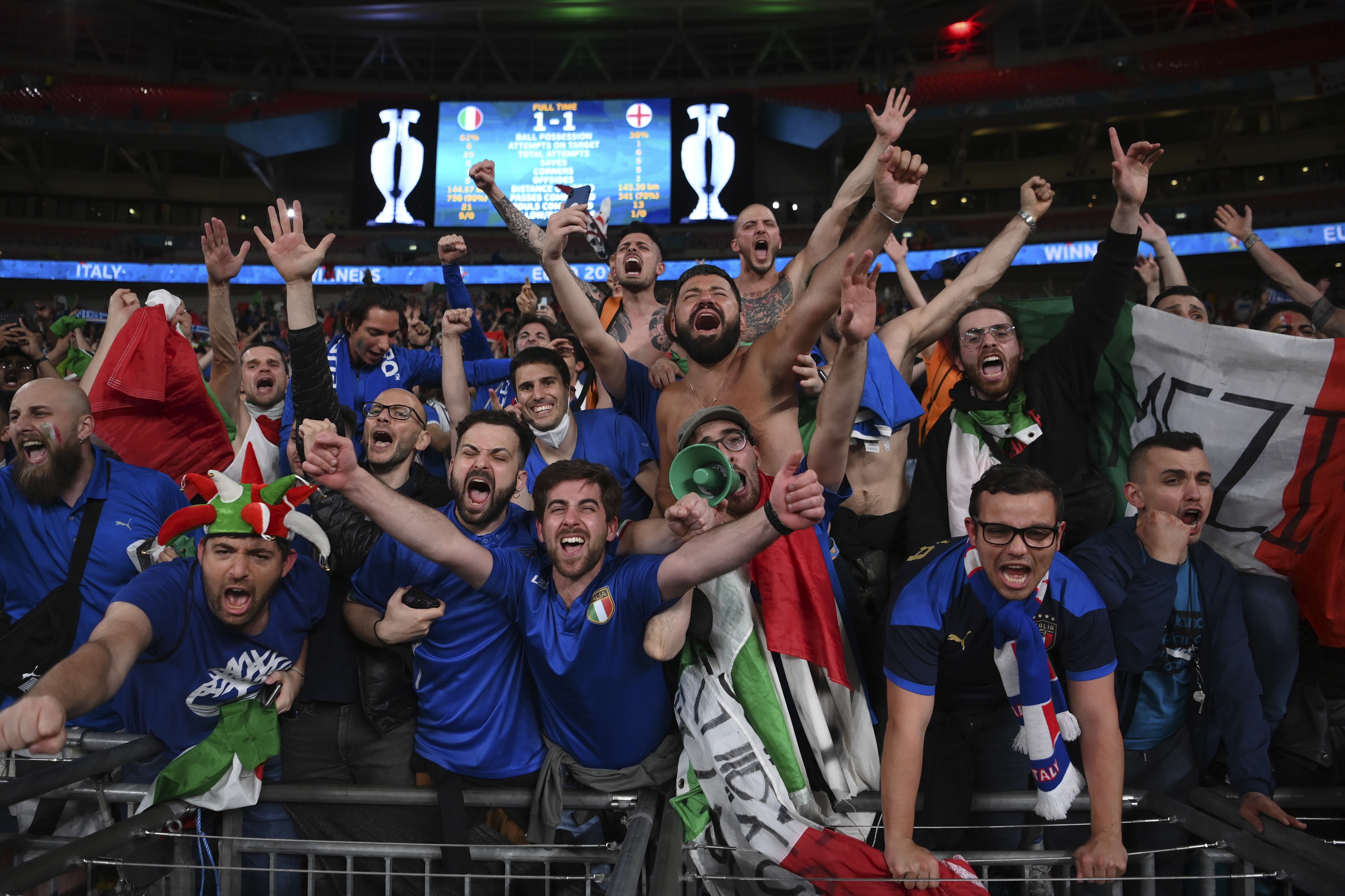Italian fans celebrate after Italy beat England in the Euro 2020 football final at Wembley stadium, London. [Laurence Griffiths/Pool via AP]