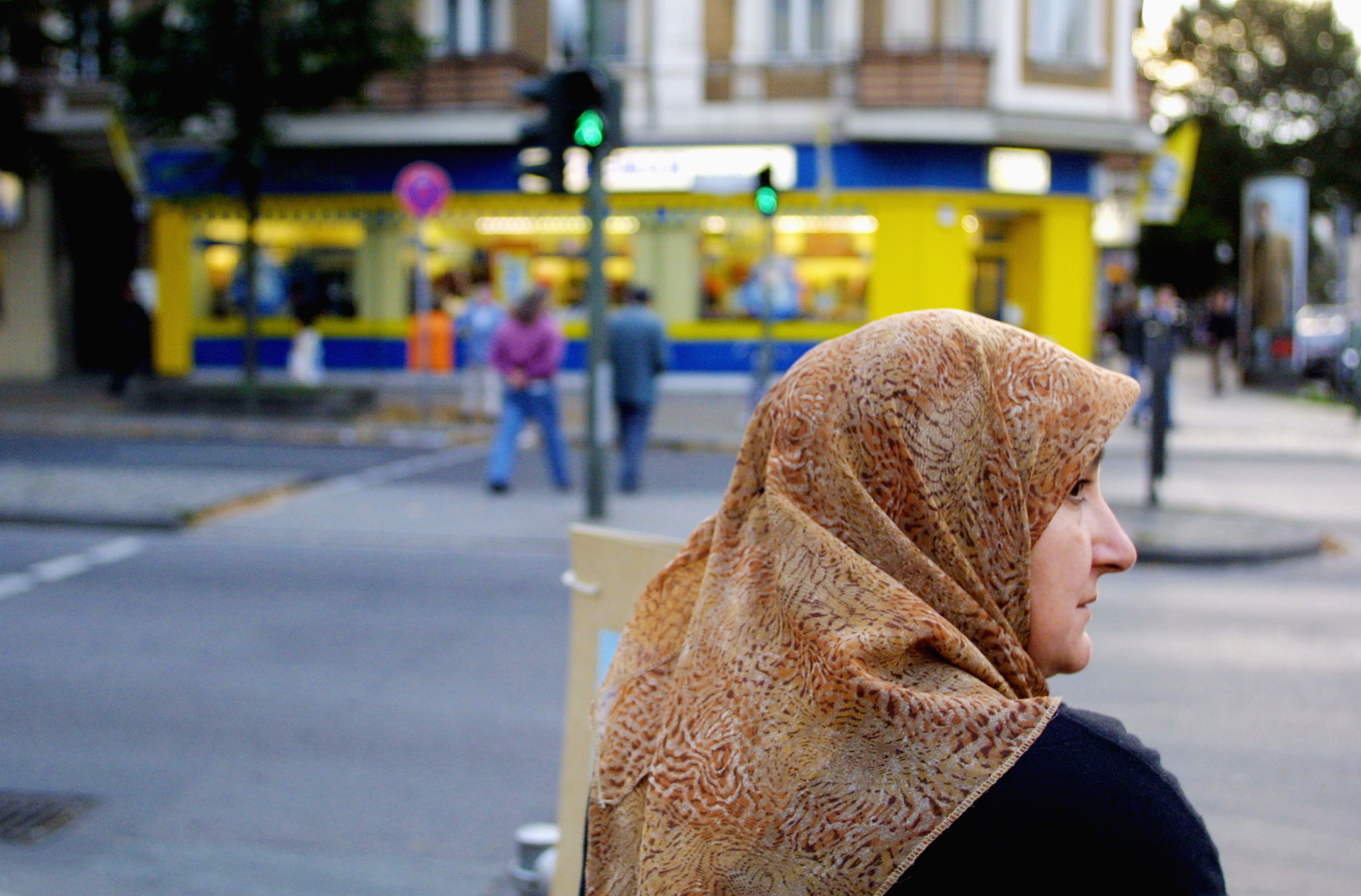 A Muslim woman waits to cross a street in Berlin's Neukoelln district. [File: Sean Gallup/Getty Images]