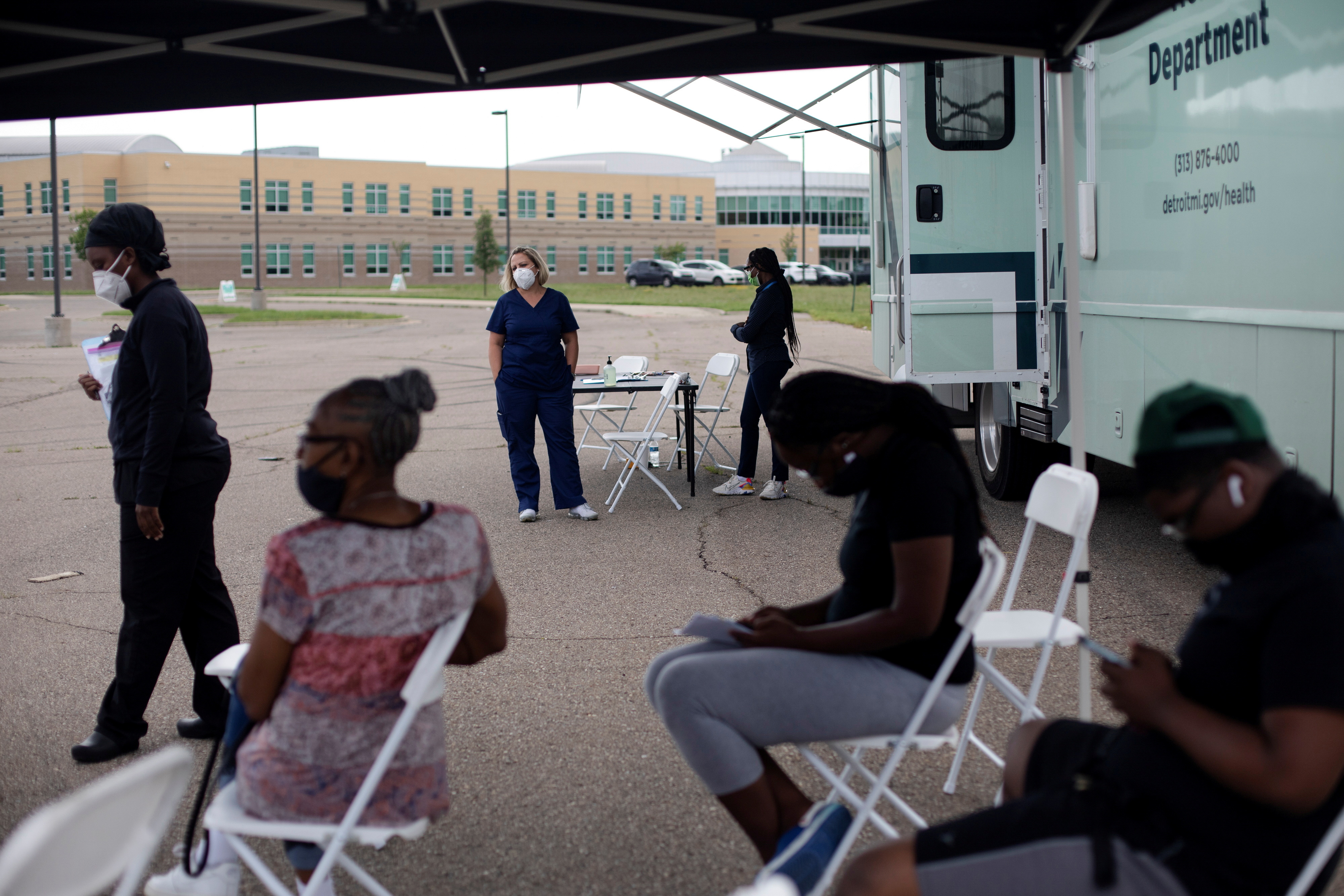 Detroit residents sit in the waiting area after receiving their first dose of a COVID-19 vaccine at a pop-up vaccination clinic in Detroit, Michigan, the United States