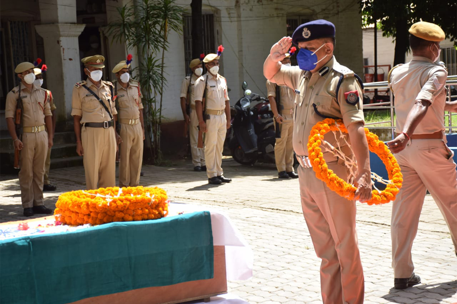 An Assam police officer pays homage to one of his six slain colleagues, Cachar, Assam [Biswa Kalyan Purkayastha/Al Jazeera]
