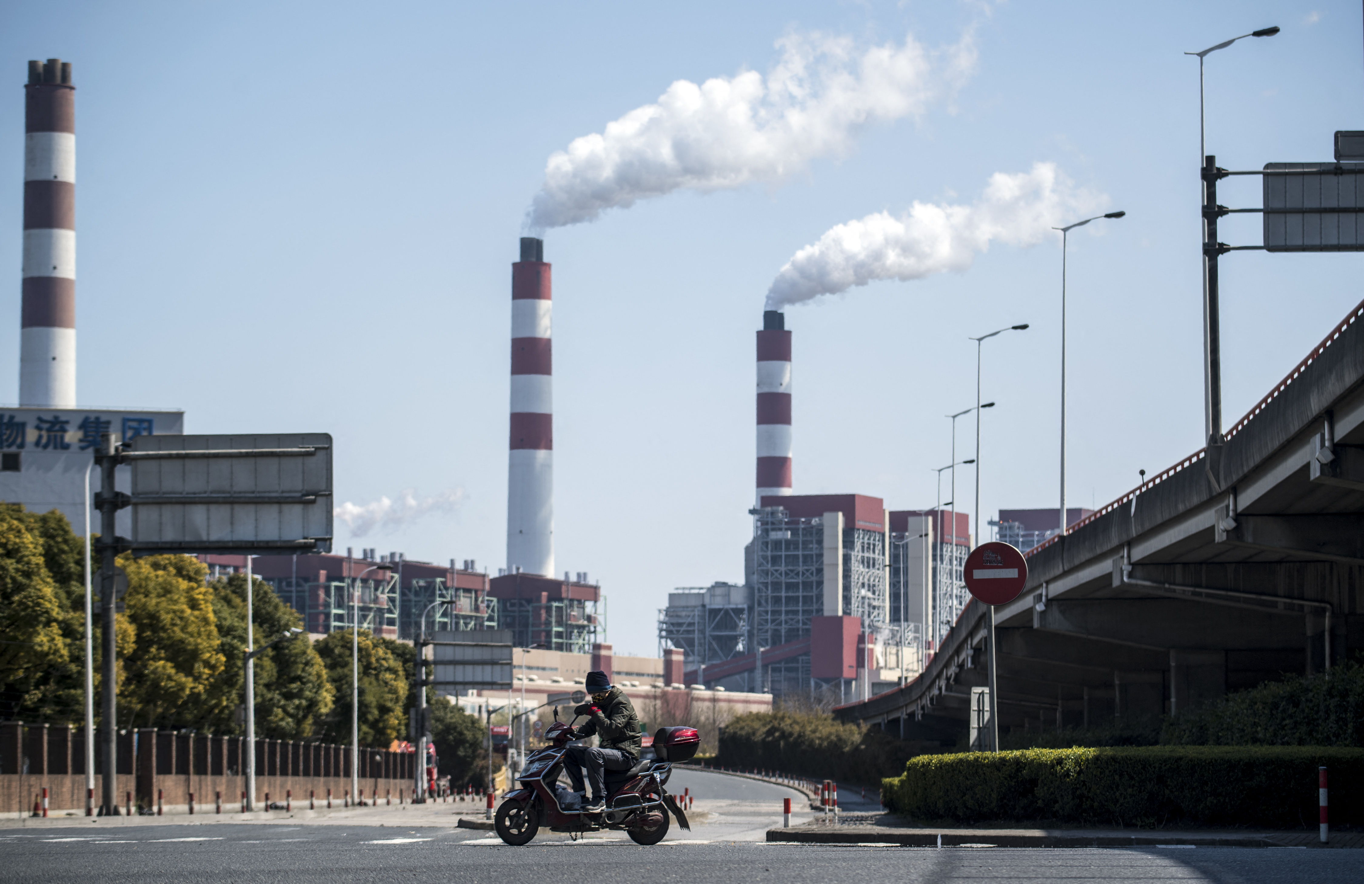 Smoke billowing from tall chimneys in China.
