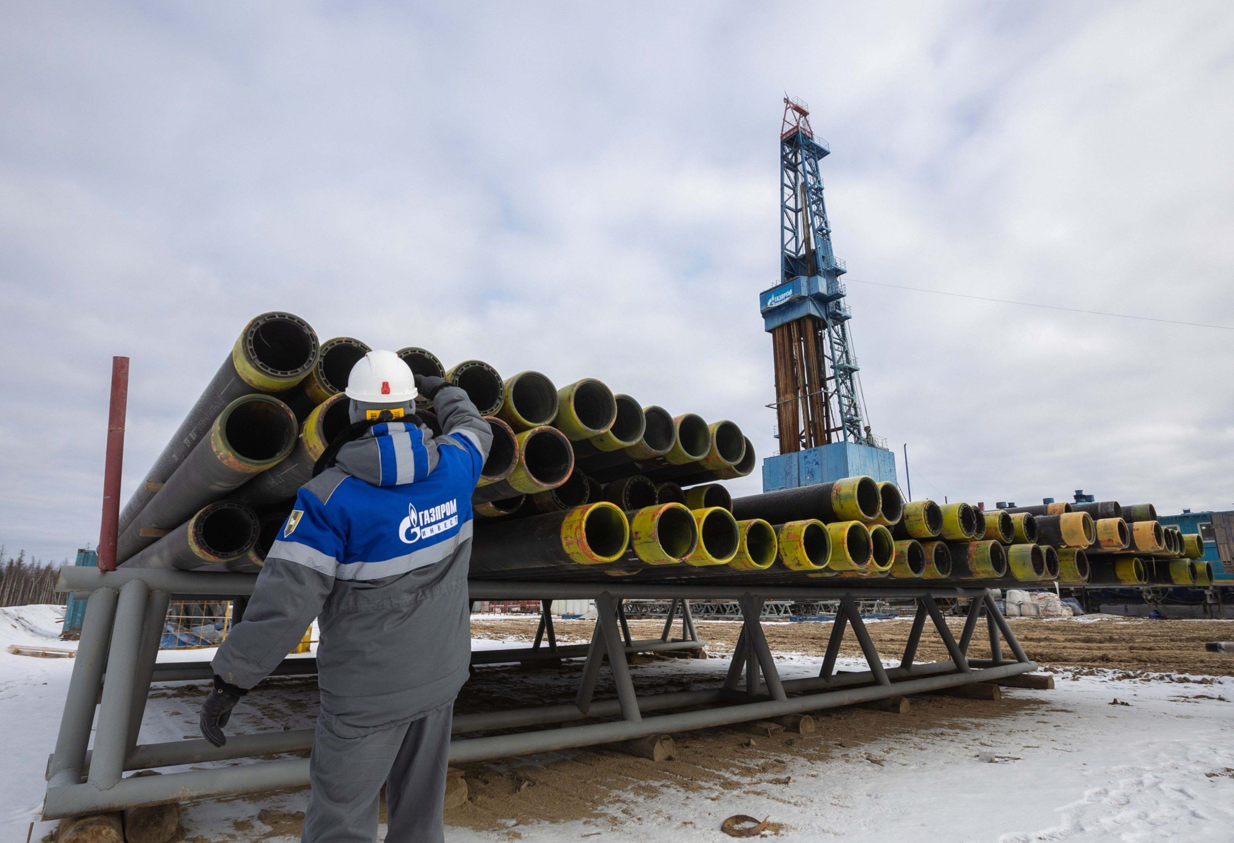 A worker inspects drilling pipes at a gas drilling.