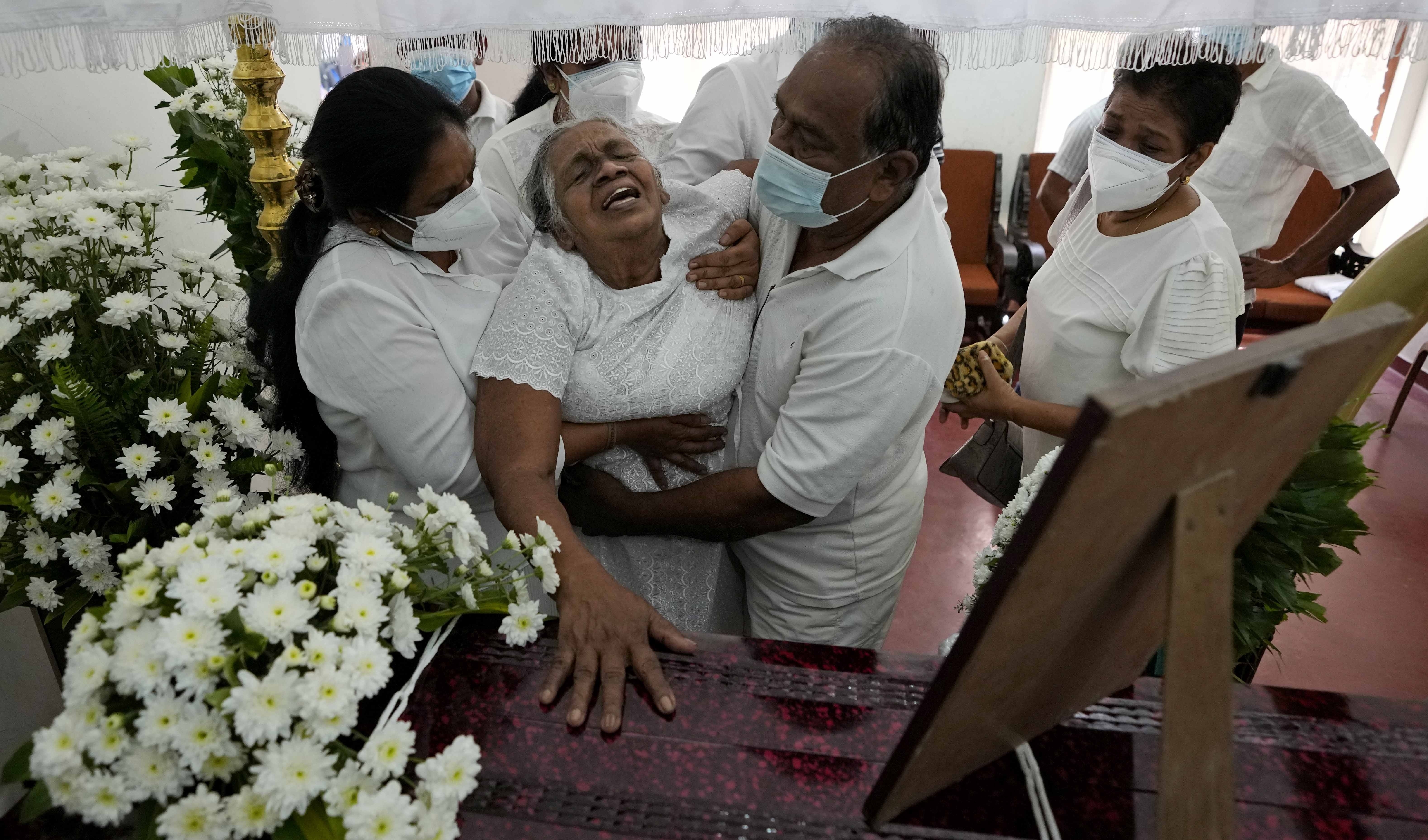 Diyawadana's mother grieves at her son's coffin after his body was returned to Sri Lanka [Eranga Jayawardena/AP Photo]