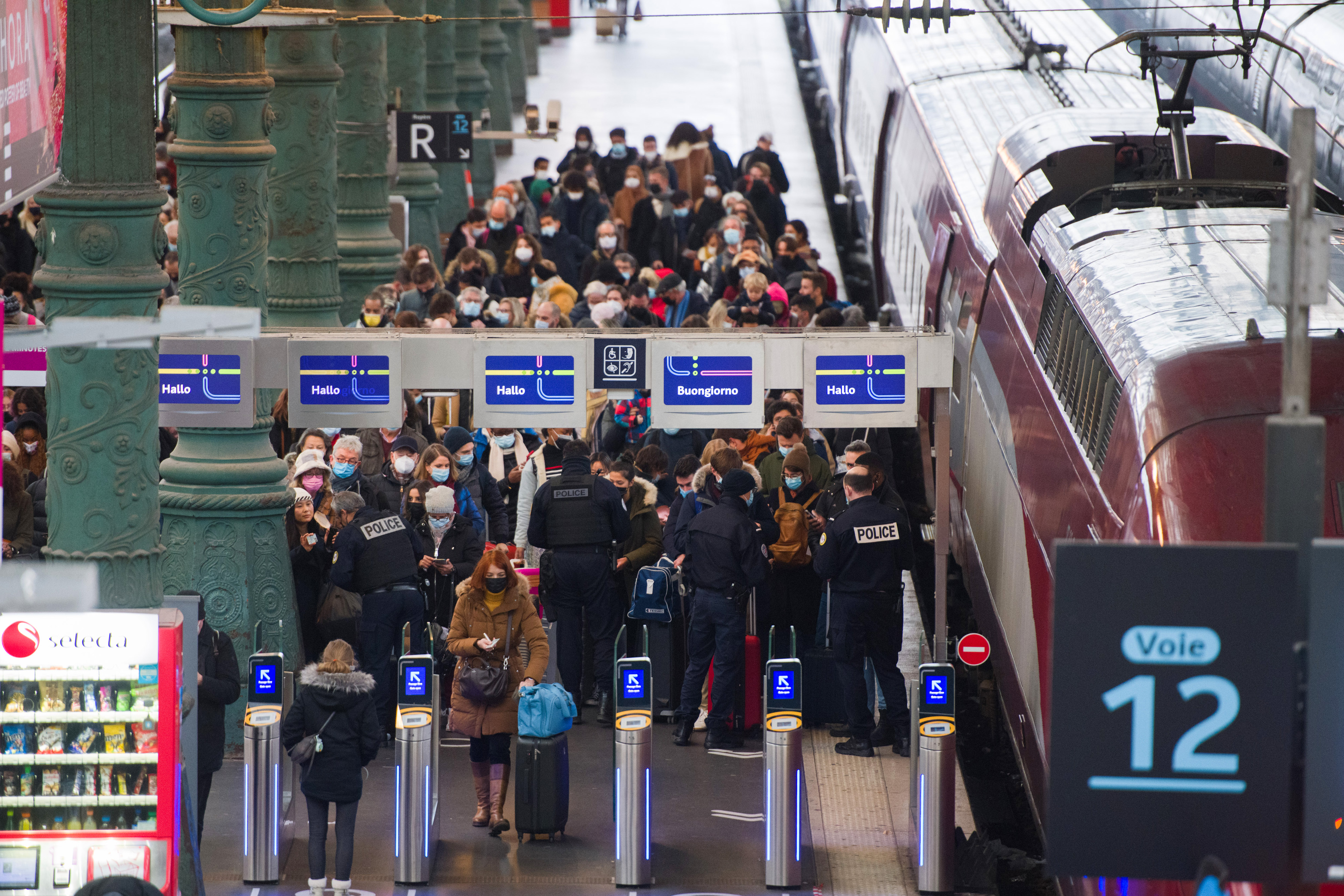 French border police check the Covid health passes of travelers on the Thalys arrivals platform at Gare du Nord train station in Paris, France