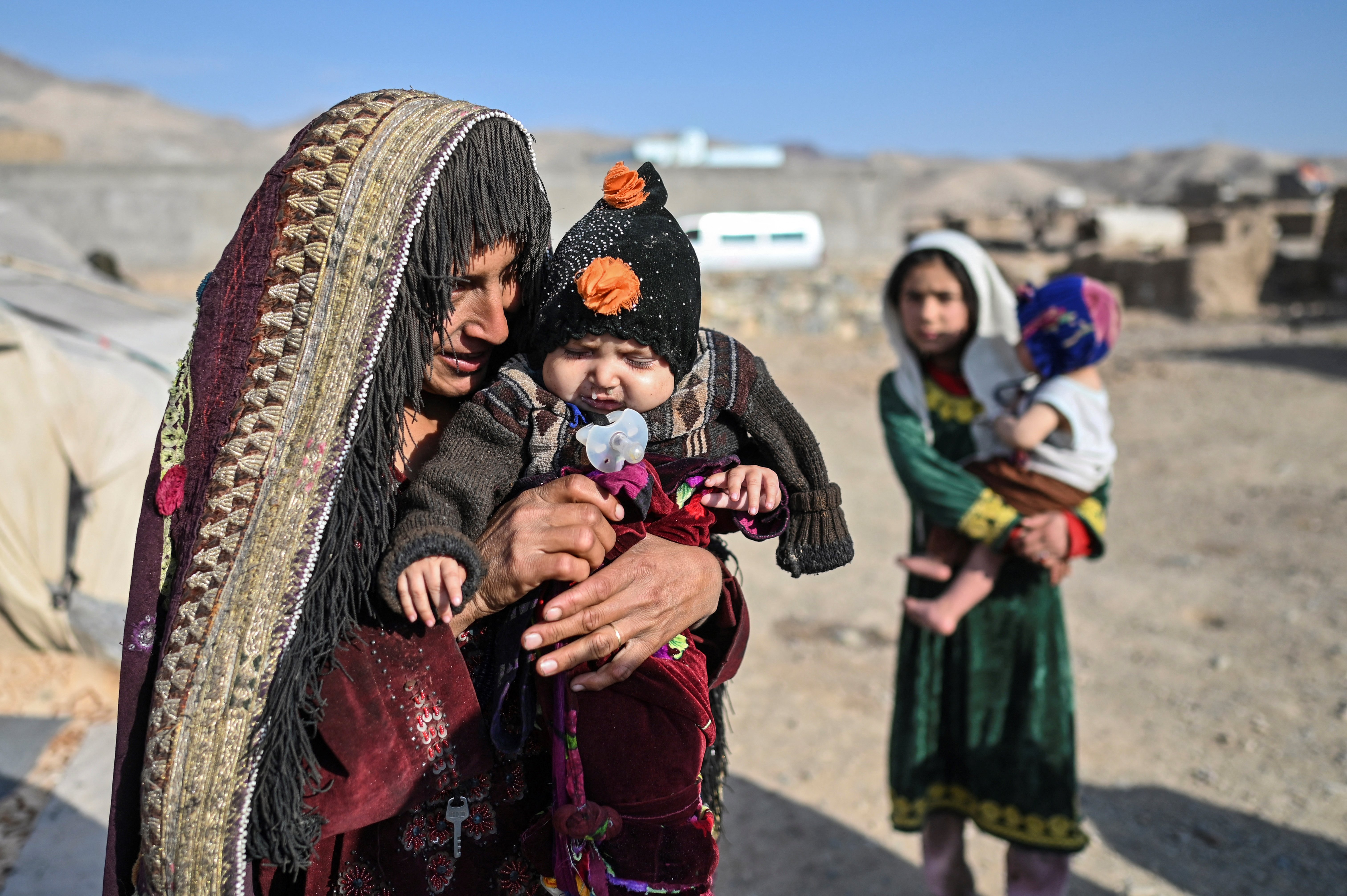 A woman holds her baby at a camp for internally displaced people