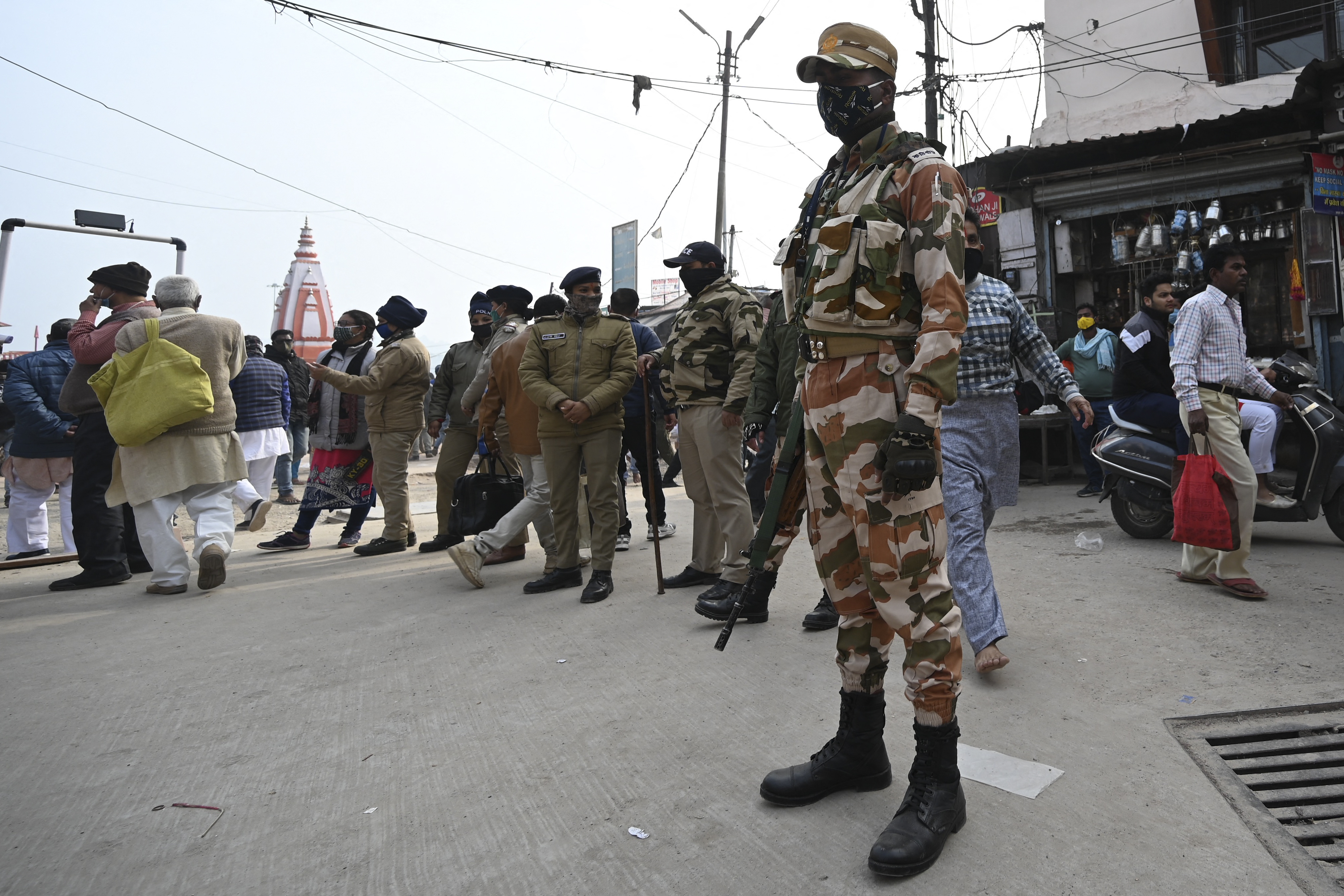 Police personnel stand guard on the banks of the River Ganges