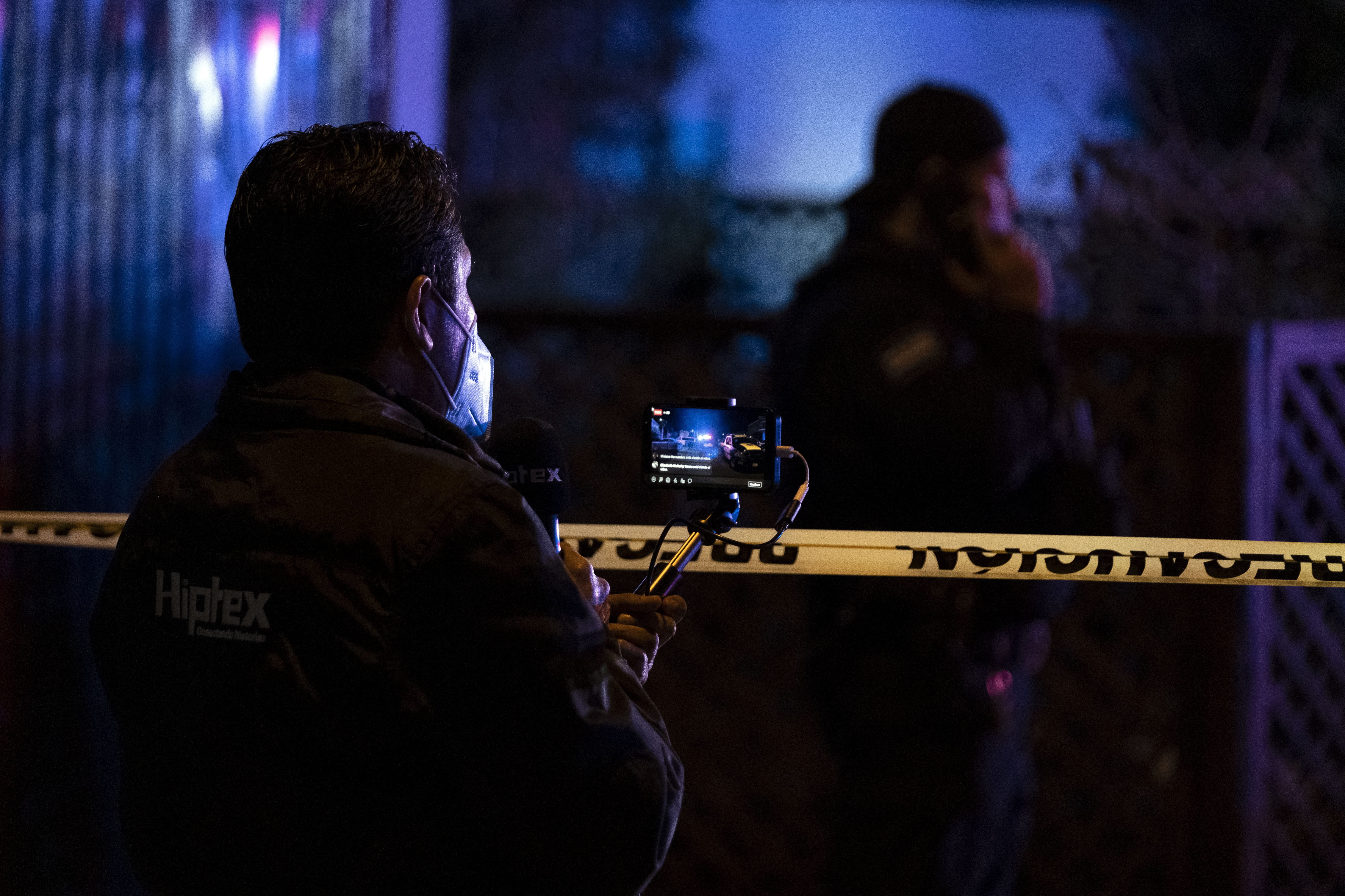 Journalists cover the crime scene where journalist Lourdes Maldonado was murdered in Tijuana's outskirts