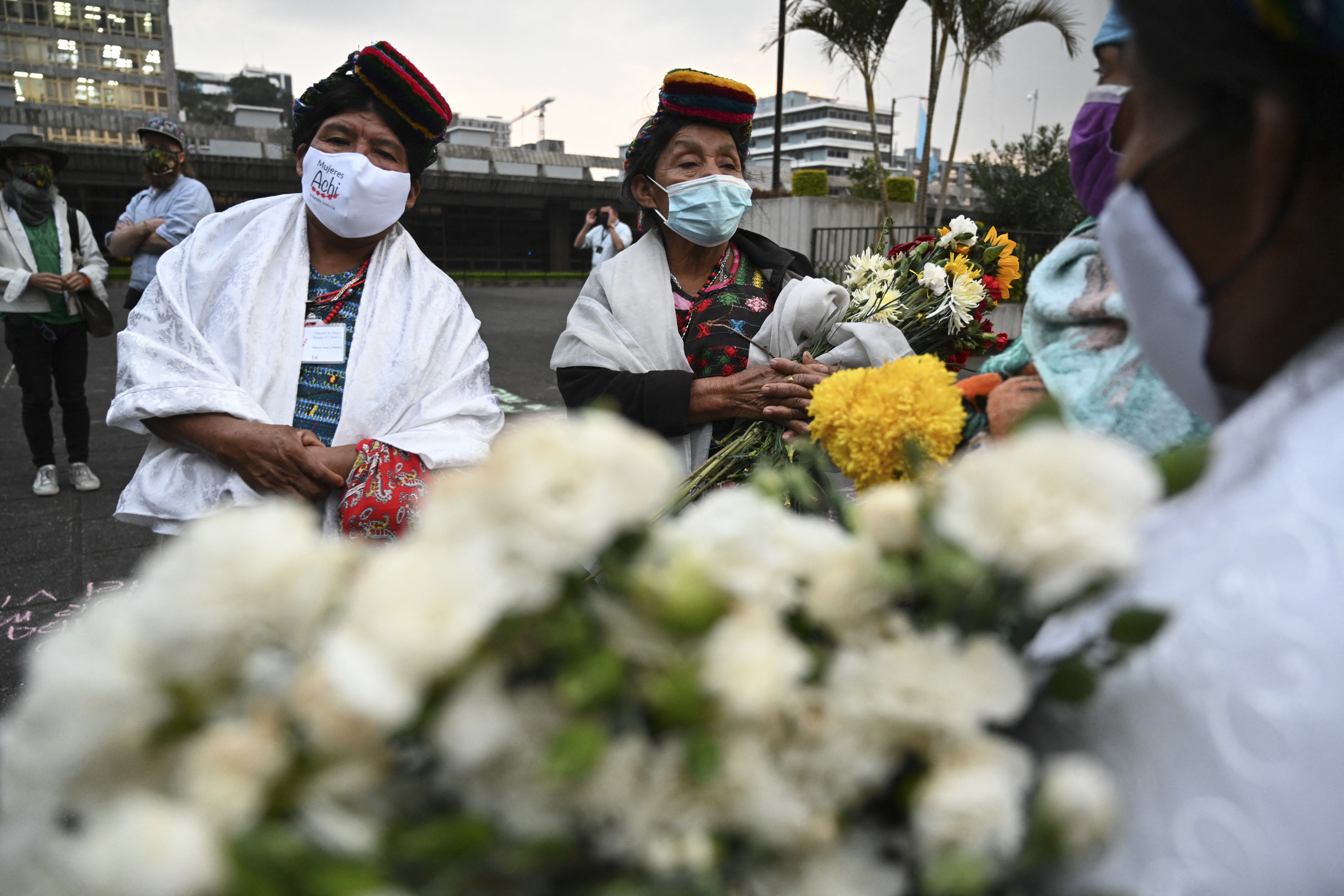 Guatemalan Achi women, victims of sexual violence during the internal armed conflict (1960-1996), react at the end of the trial against five former Guatemalan Civil Patrol (PAC) members, outside the Justice Palace in Guatemala on January 24, 2022.