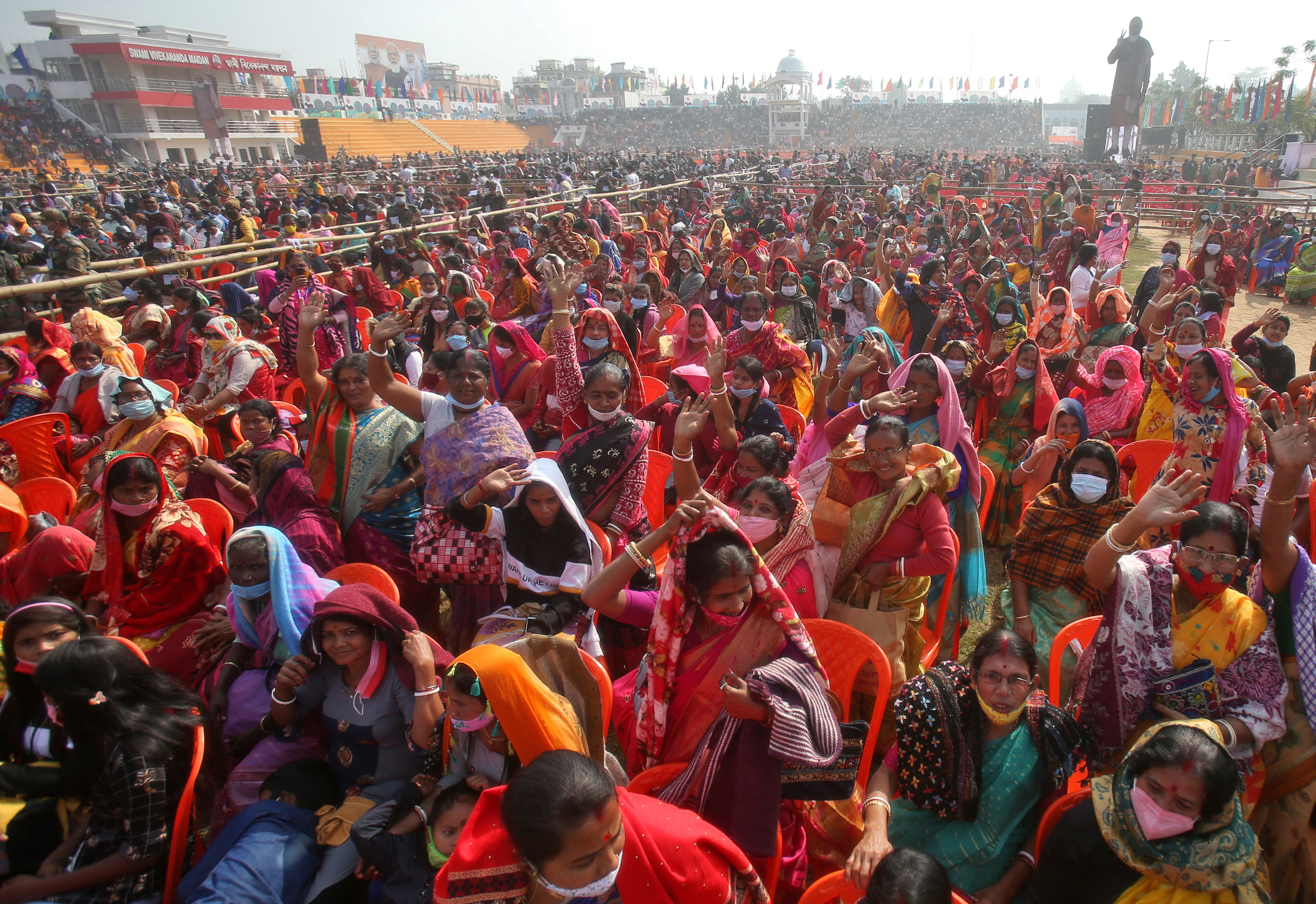 People wave as they attend a rally addressed by India nPrime Minister Narendra Modi