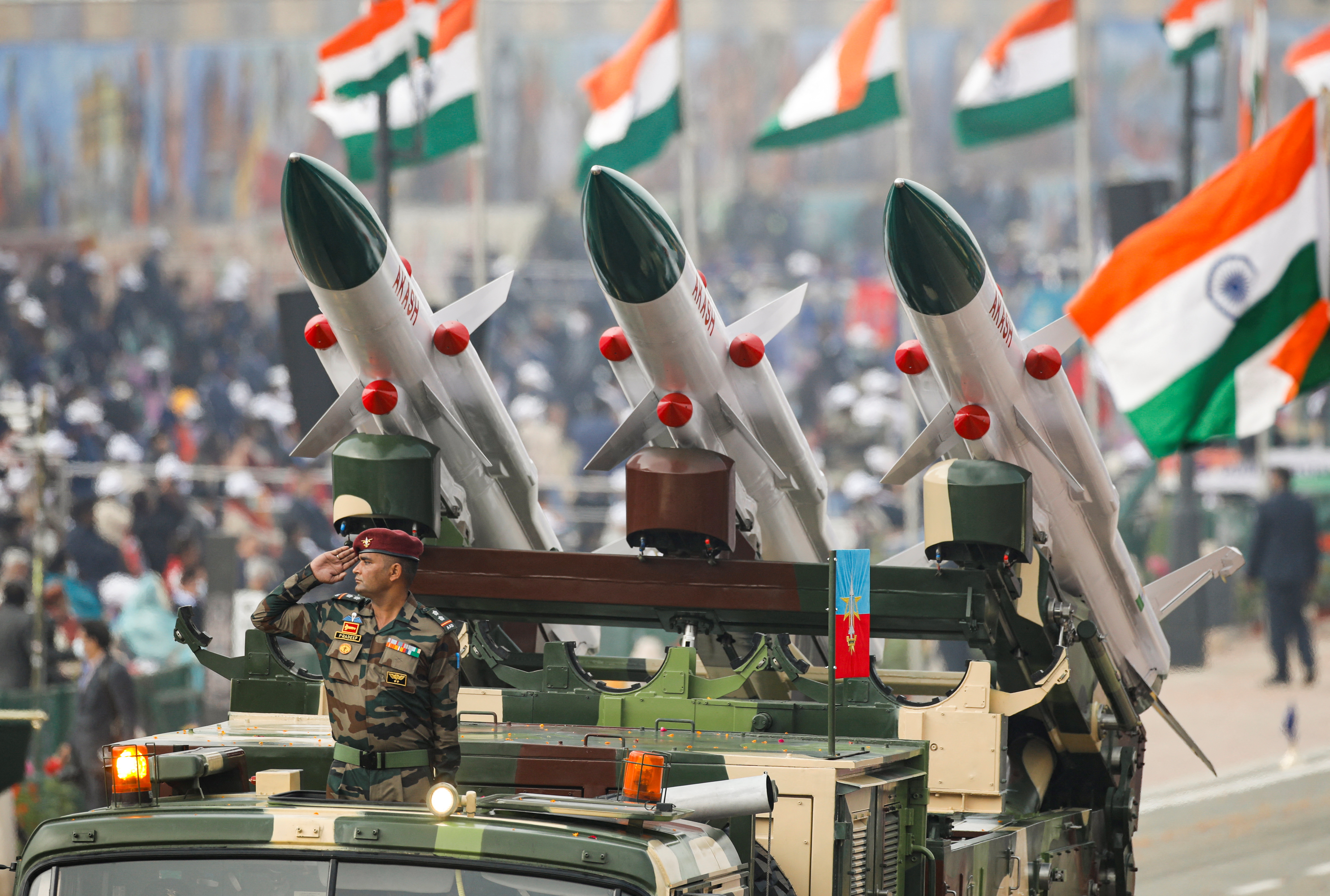 An Indian soldier salutes while standing in a vehicle during the Republic Day parade in New Delhi