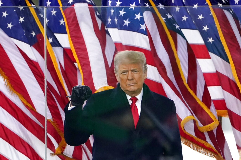 Then-President Donald Trump gestures as he arrives to speak at a rally in Washington.