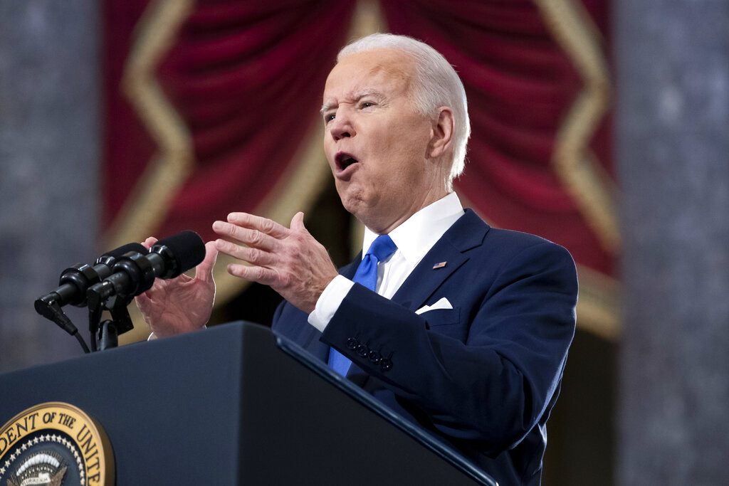 President Joe Biden behind a podium at the US Capitol on the anniversary of the January 6 insurrection