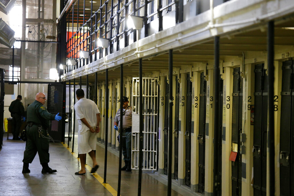 A condemned inmate is led out of his east block cell on death row at San Quentin State Prison.