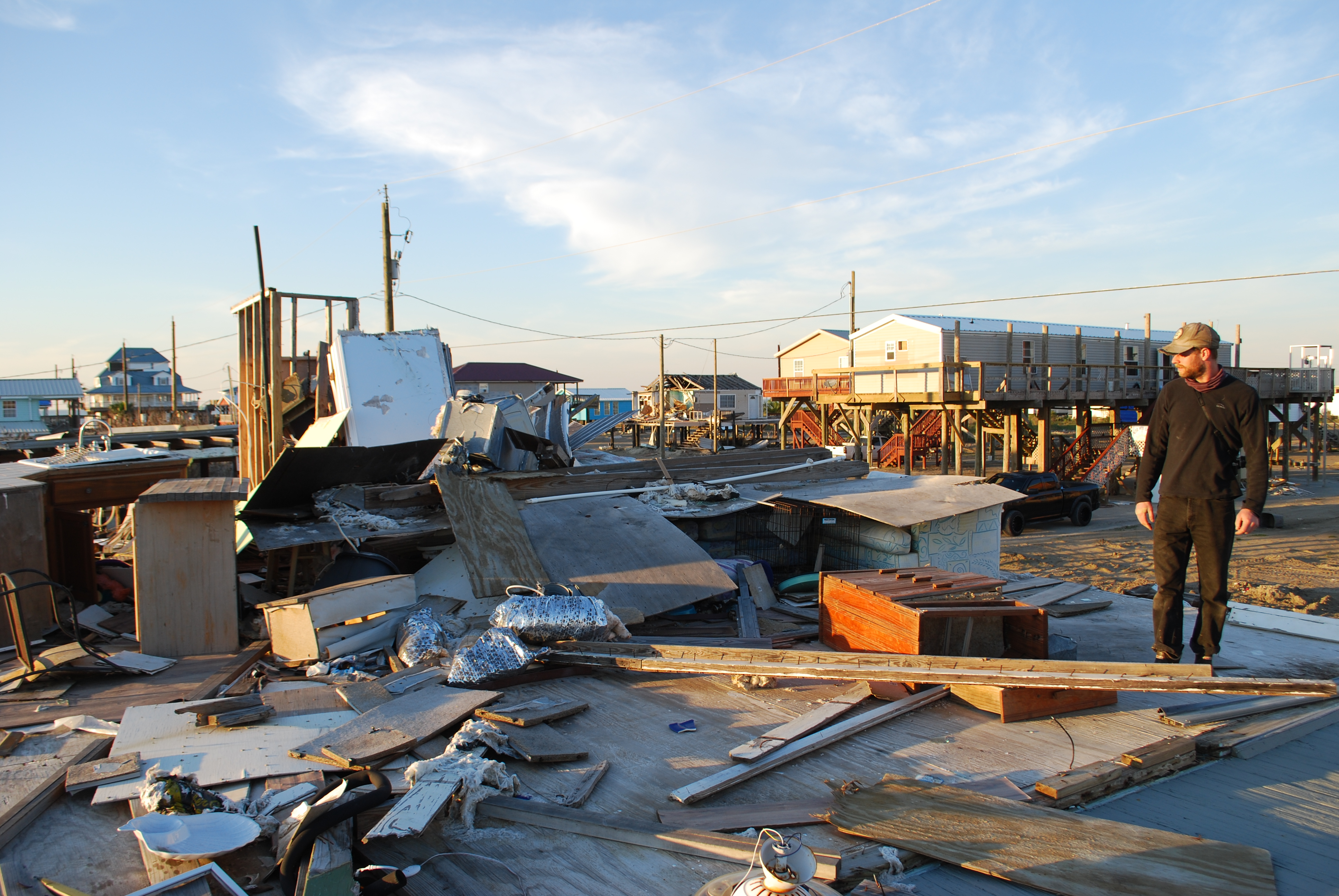 Lacava surveys the remains of a house destroyed by Hurricane Ida in Grand Isle.