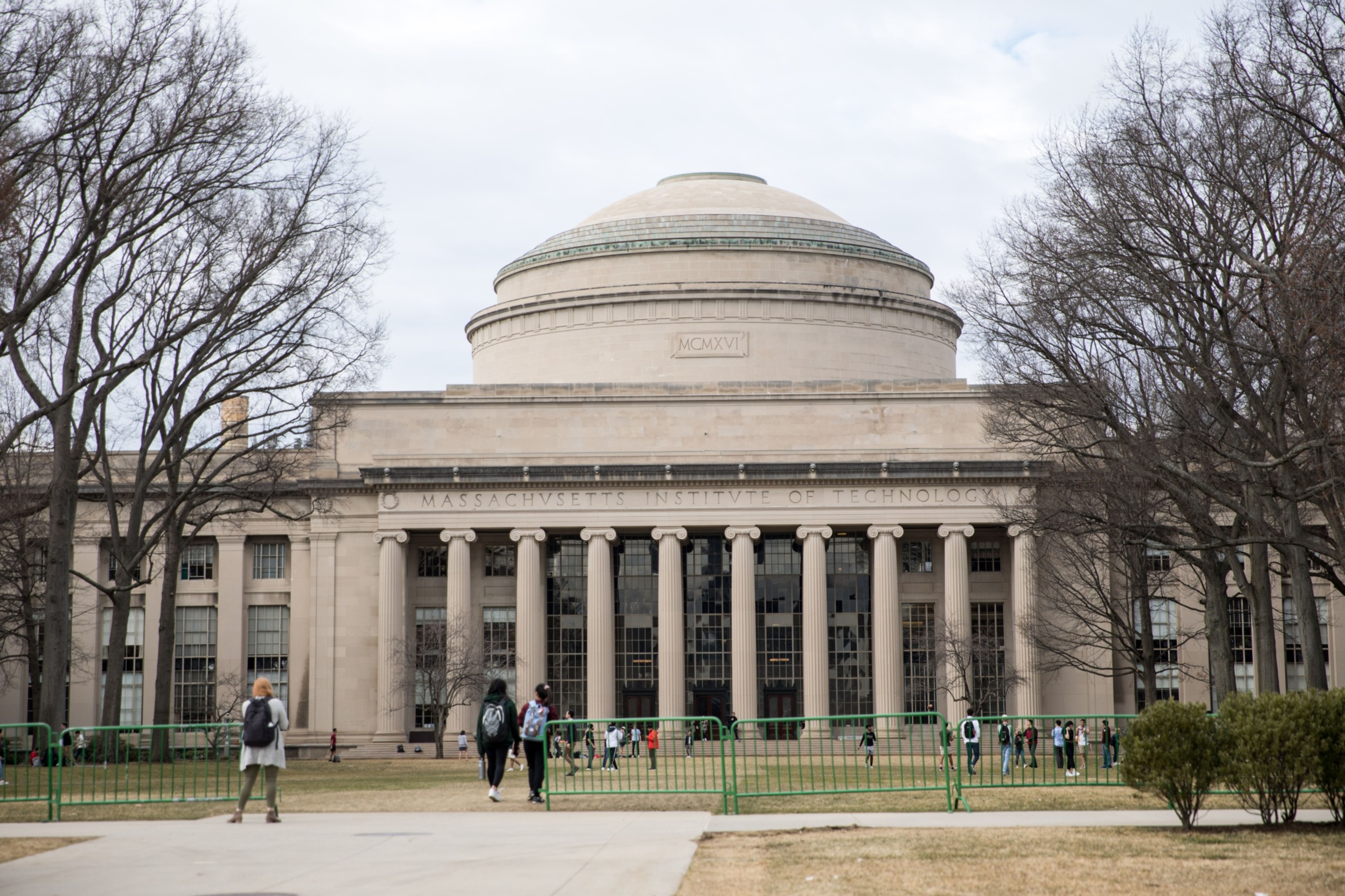 Pedestrians walk past the Maclaurin Building at the Massachusetts Institute of Technology (MIT) campus in Cambridge, Massachusetts, US