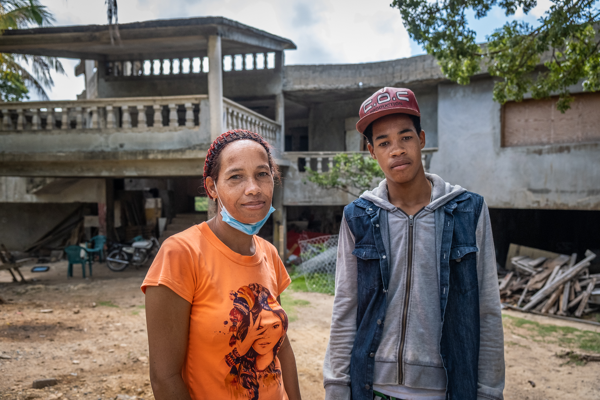 Engrid Rodriquez, a Dominican woman, stands with one of her sons