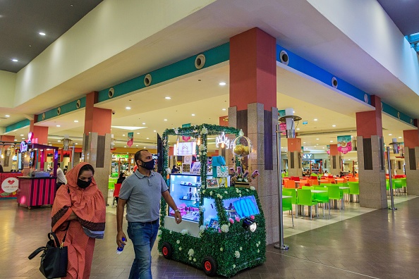 Shoppers walk past a food court at the Dolmen Mall Clifton in Karachi, Pakistan.