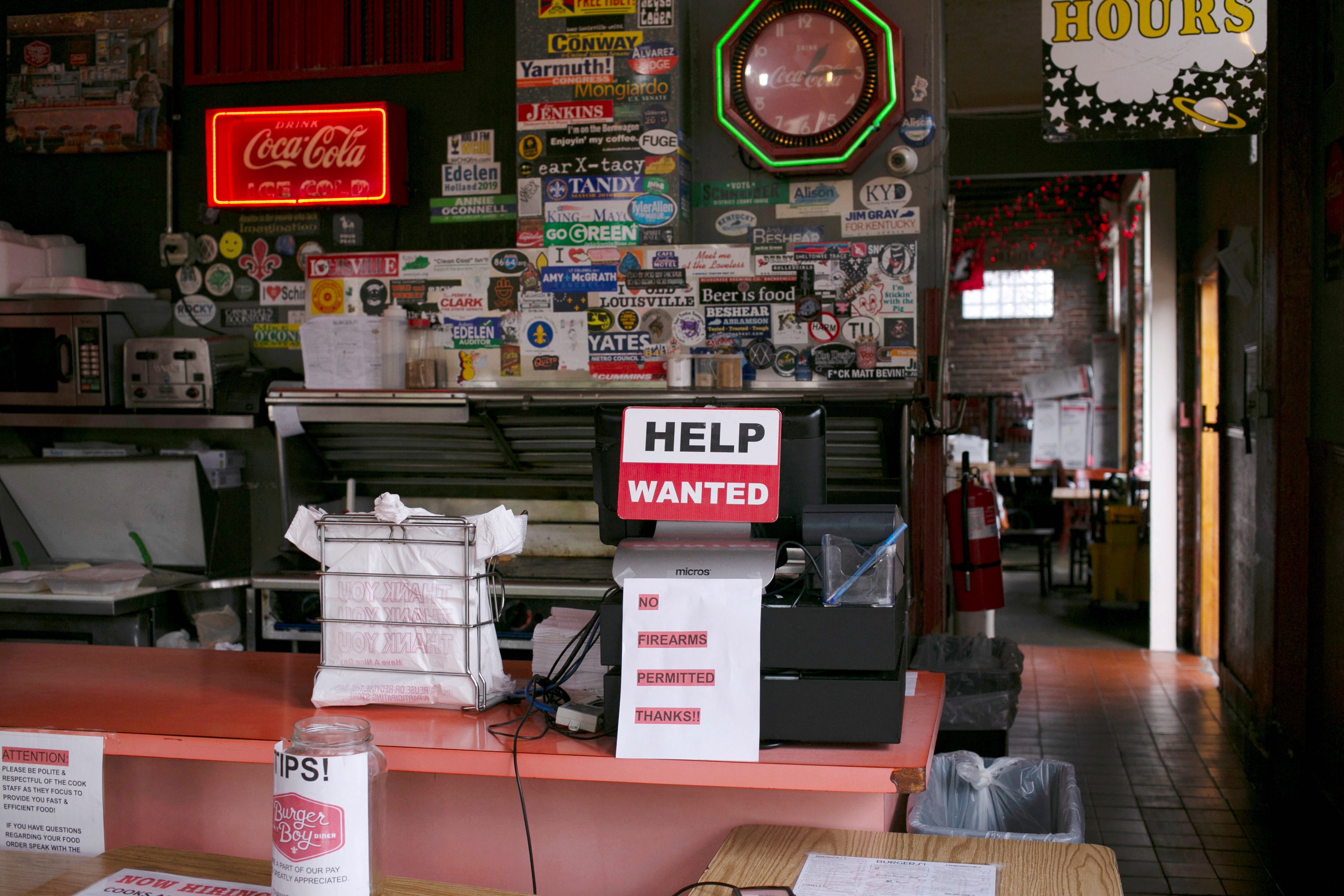 A hiring sign is seen at the register of Burger Boy restaurant, as many restaurant businesses face staffing shortages in Louisville, Kentucky, US