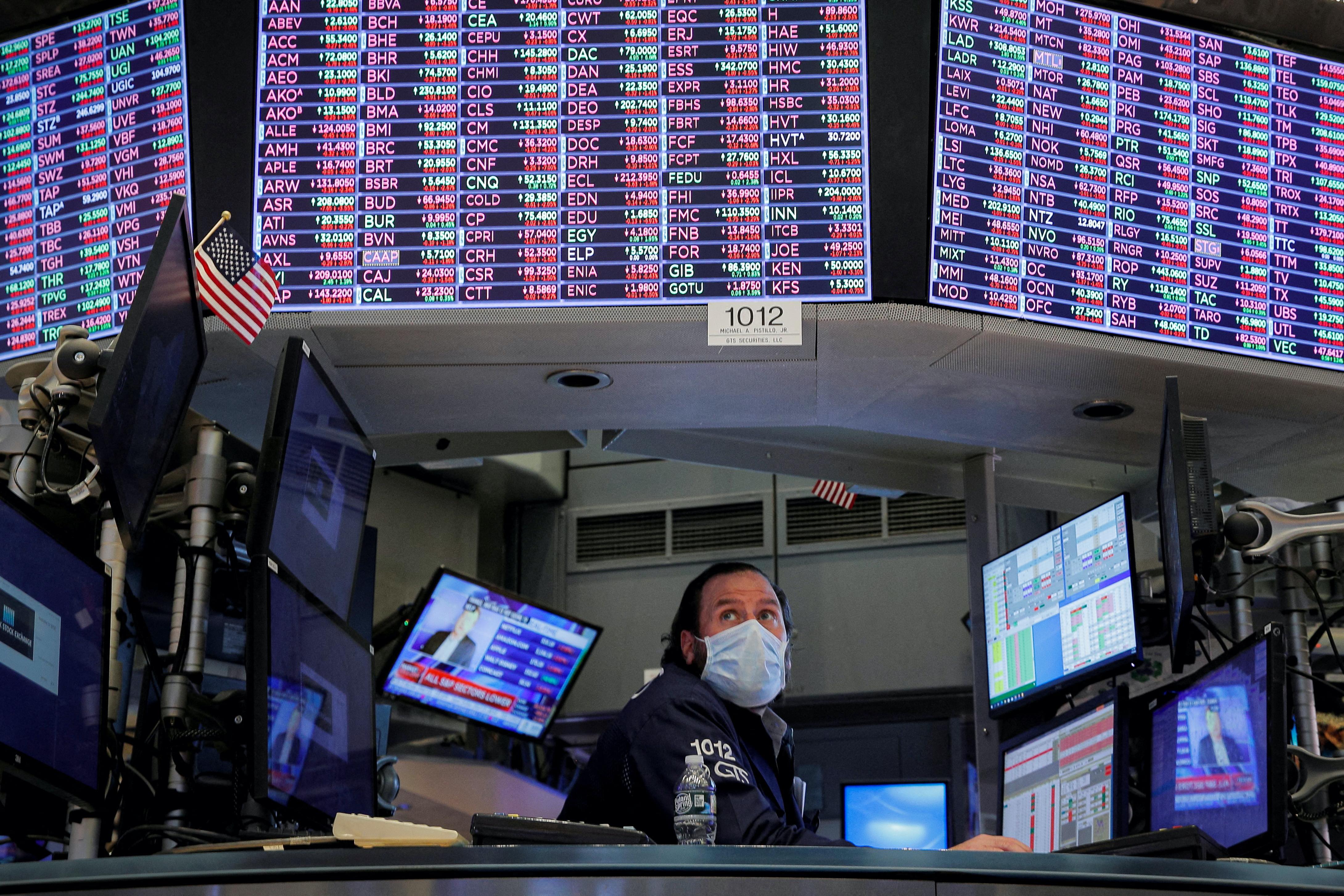A specialist trader works inside a booth on the floor of the New York Stock Exchange