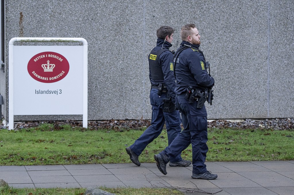 Armed police officers patrol the court of Roskilde's specially built courtroom