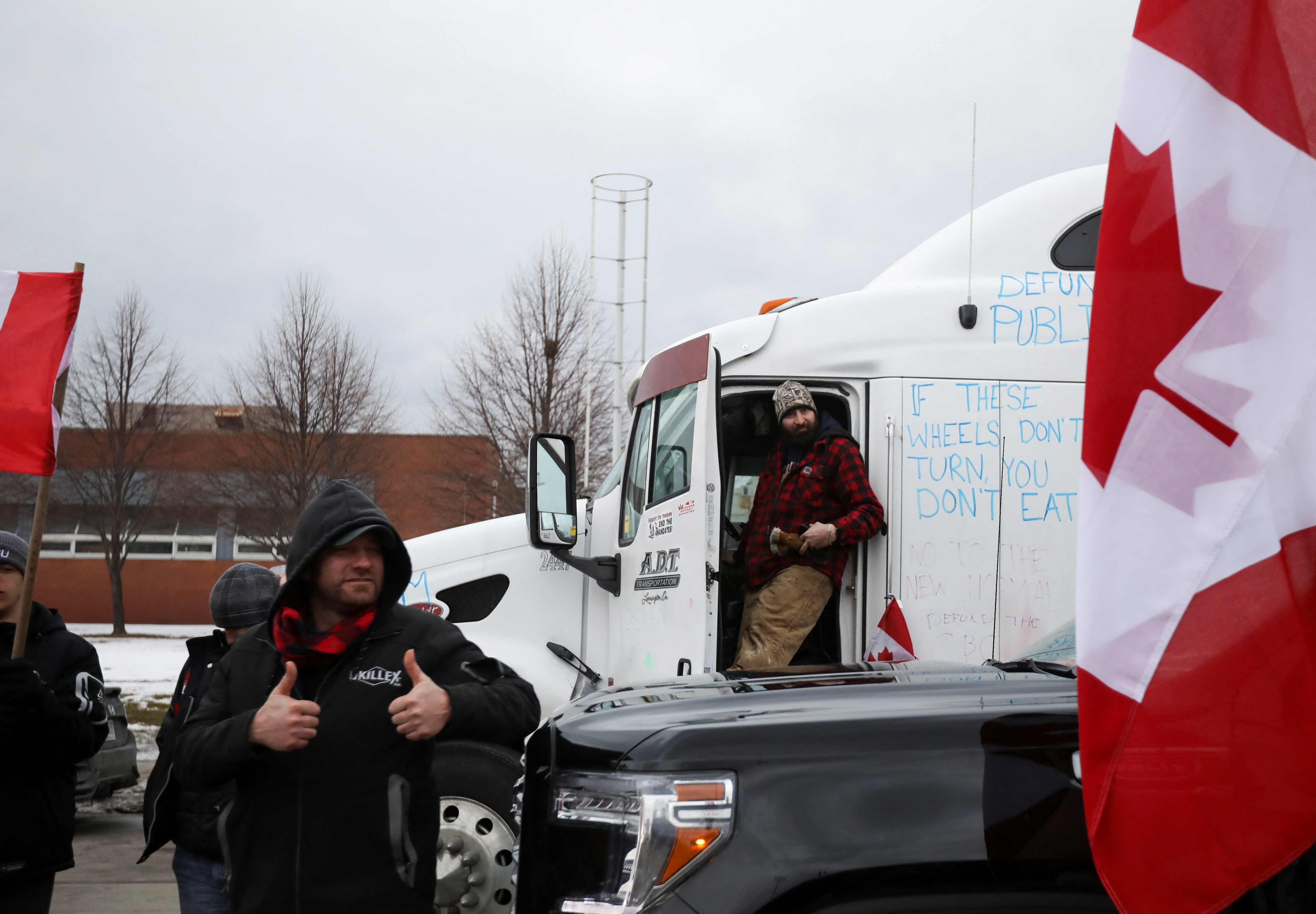 A protestor gestures as the Ambassador Bridge