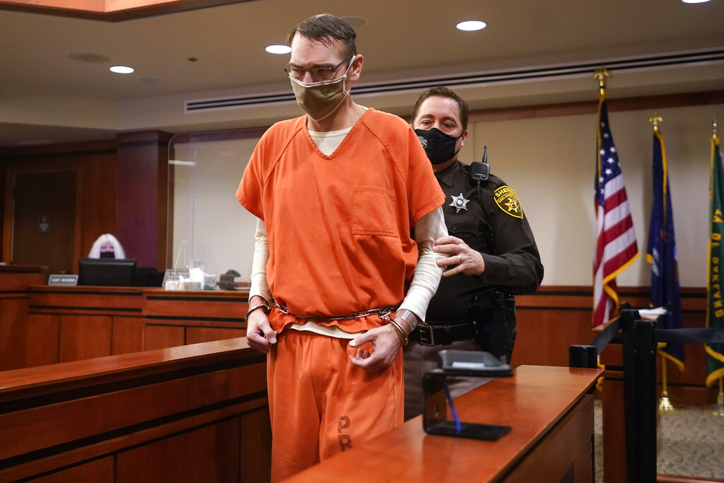 James Crumbley, father of Ethan Crumbley, a teenager accused of killing four students in a shooting at Oxford High School, arrives dressed in orange prison uniform in court for a preliminary hearing on involuntary manslaughter charges.