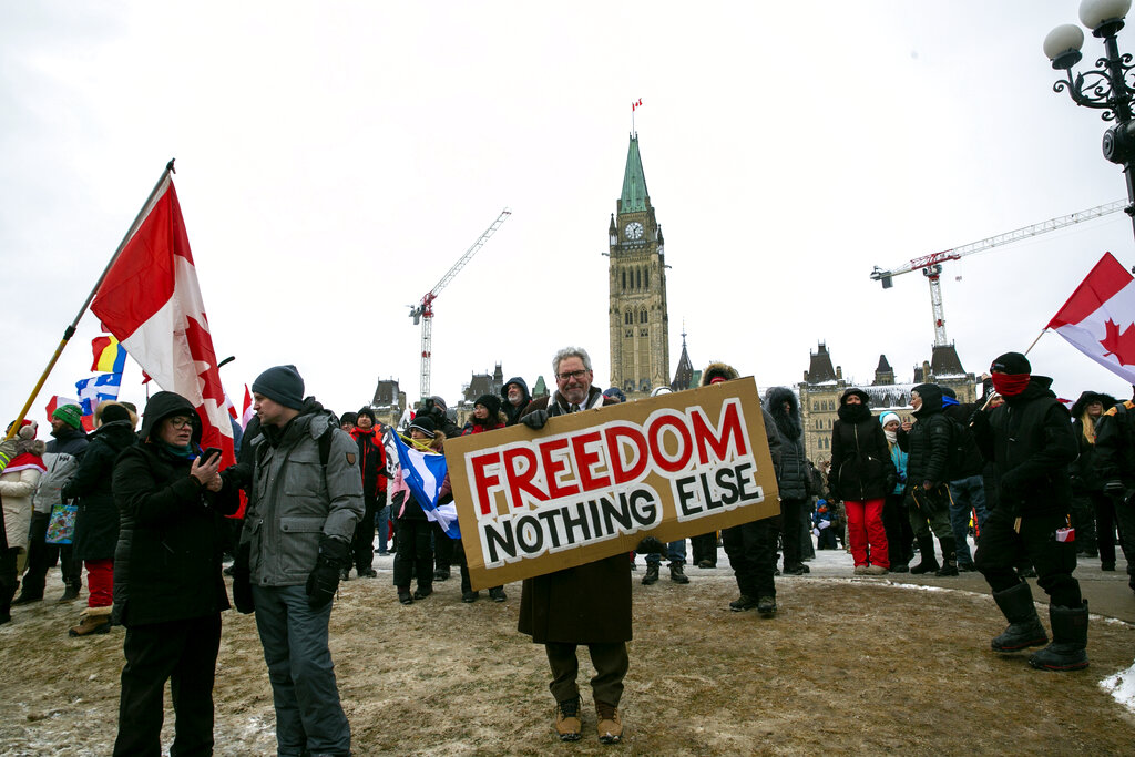 Don Stephens, 65, a retired graphic designer, holds a sign on Parliament Hill to support trucks lined up in protest of COVID-19 vaccine mandates.