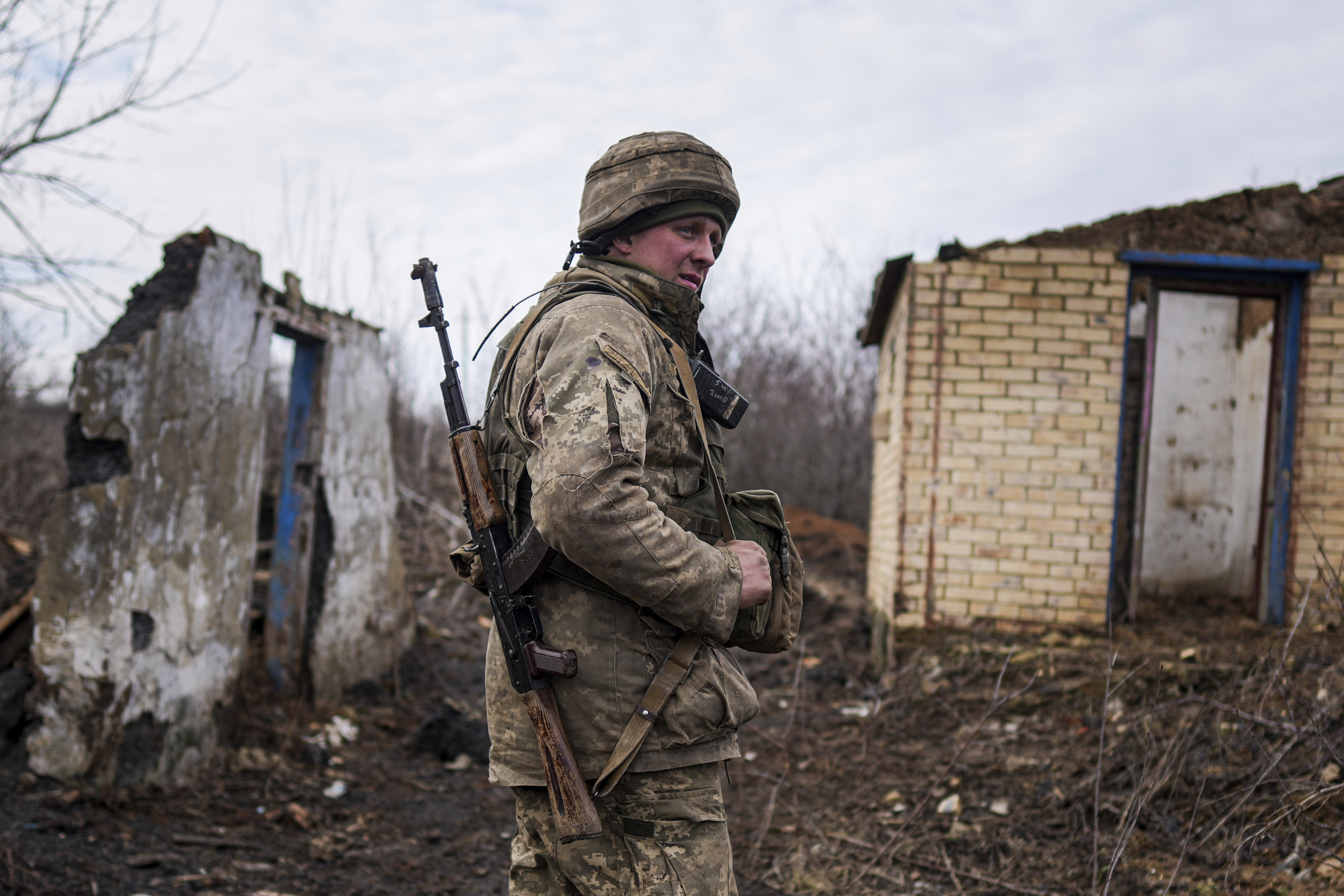 A Ukrainian serviceman stands at his position at the line of separation between Ukraine-held territory and rebel-held territory near Svitlodarsk, eastern Ukraine