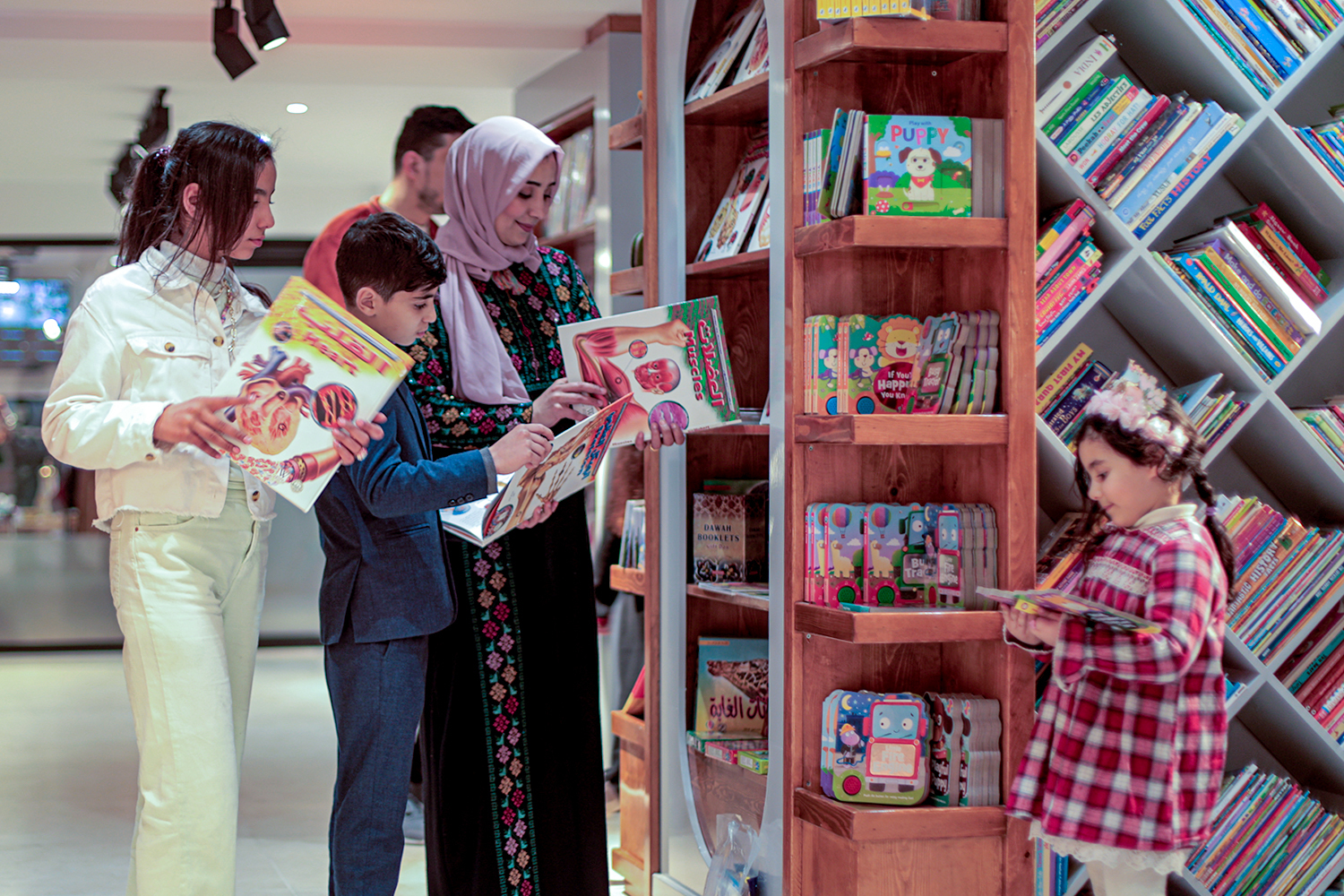 A family looks at books in a store