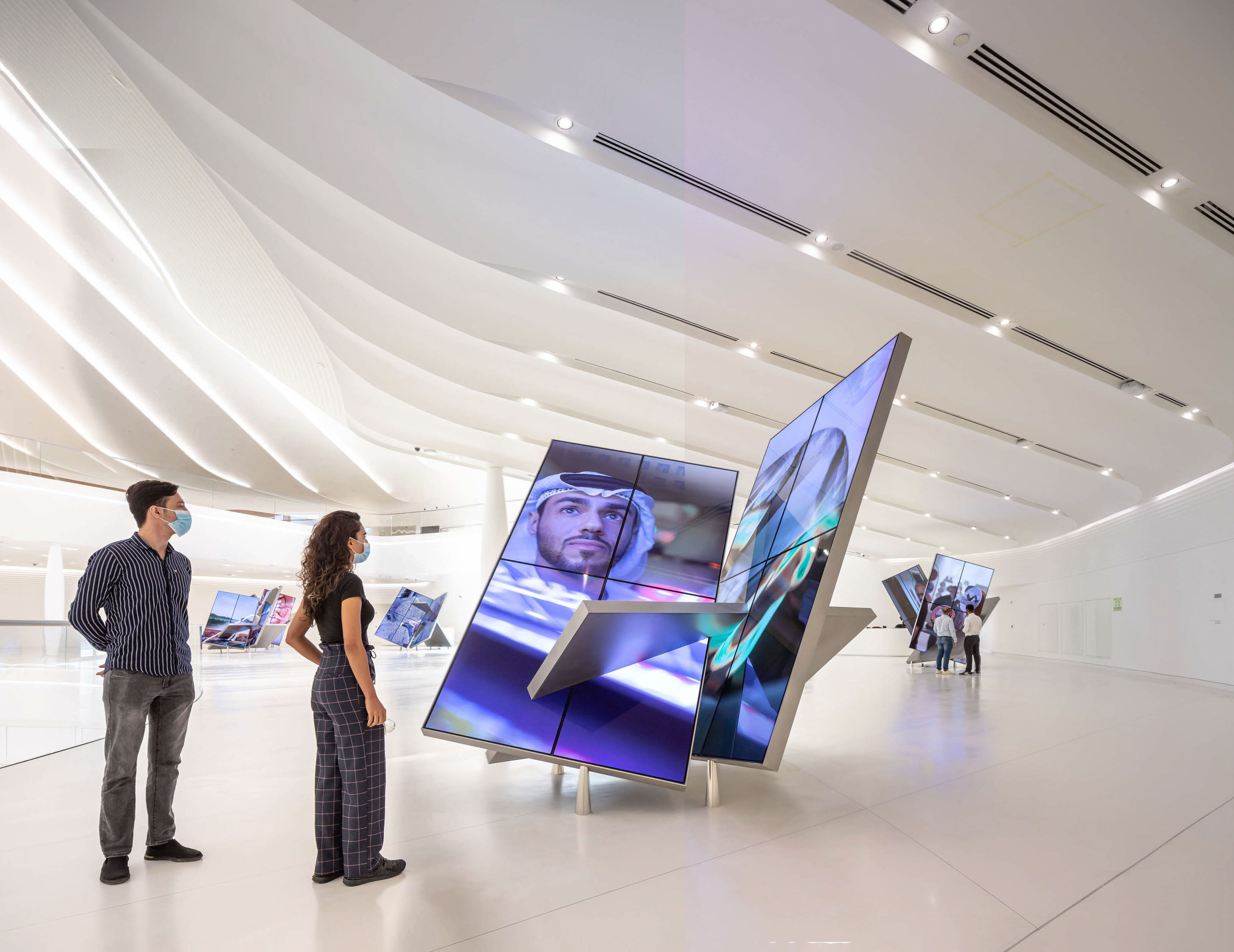 Visitors stand in front of an innovative screen inside the 'The Dreamers Who Do' section of the UAE Pavilion