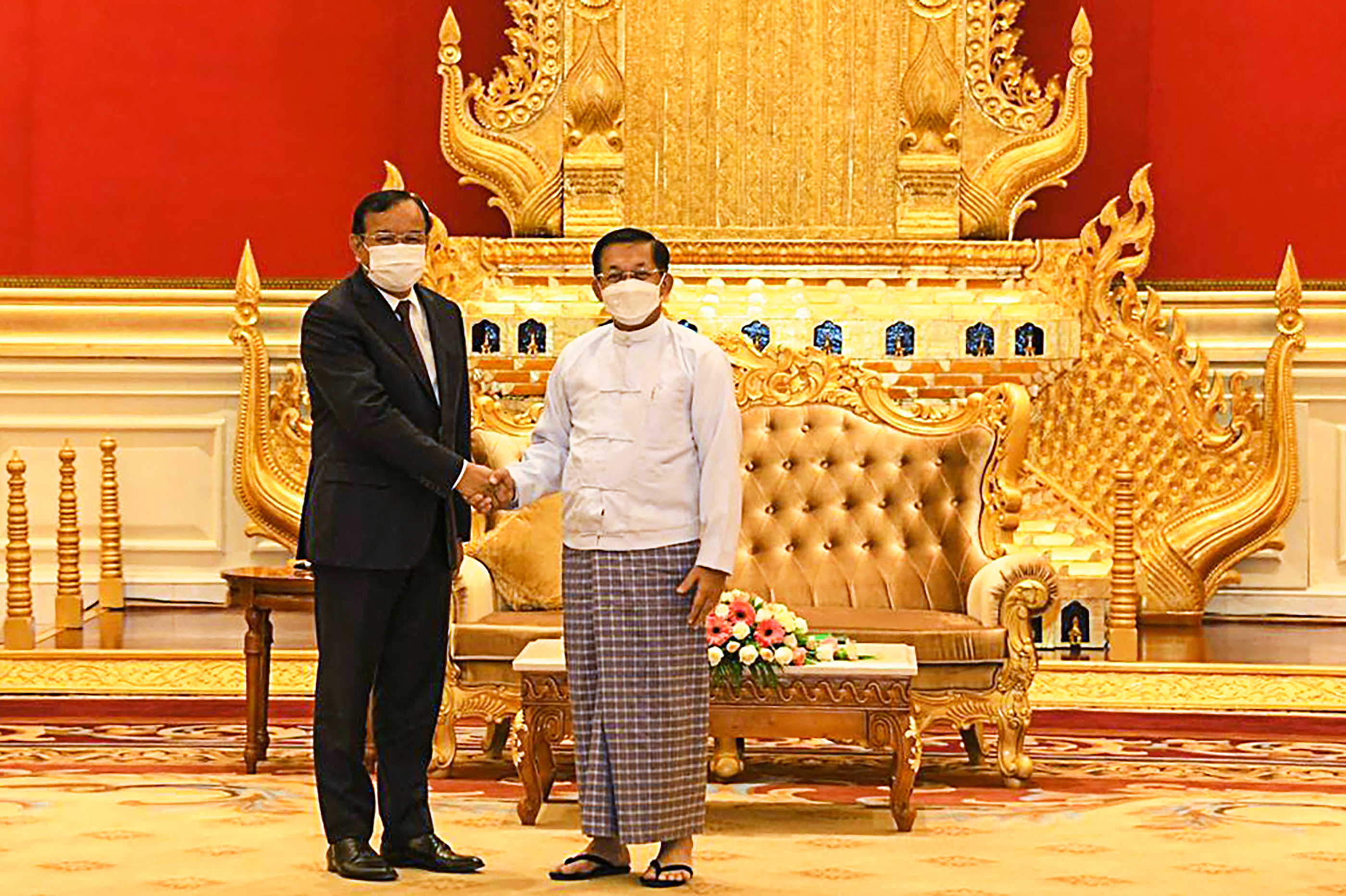 The ASEAN envoy in a western-style suit meets Myanmar coup leader Min Aung Hlaing, wearing a traditional outfit, in the capital Naypyidaw