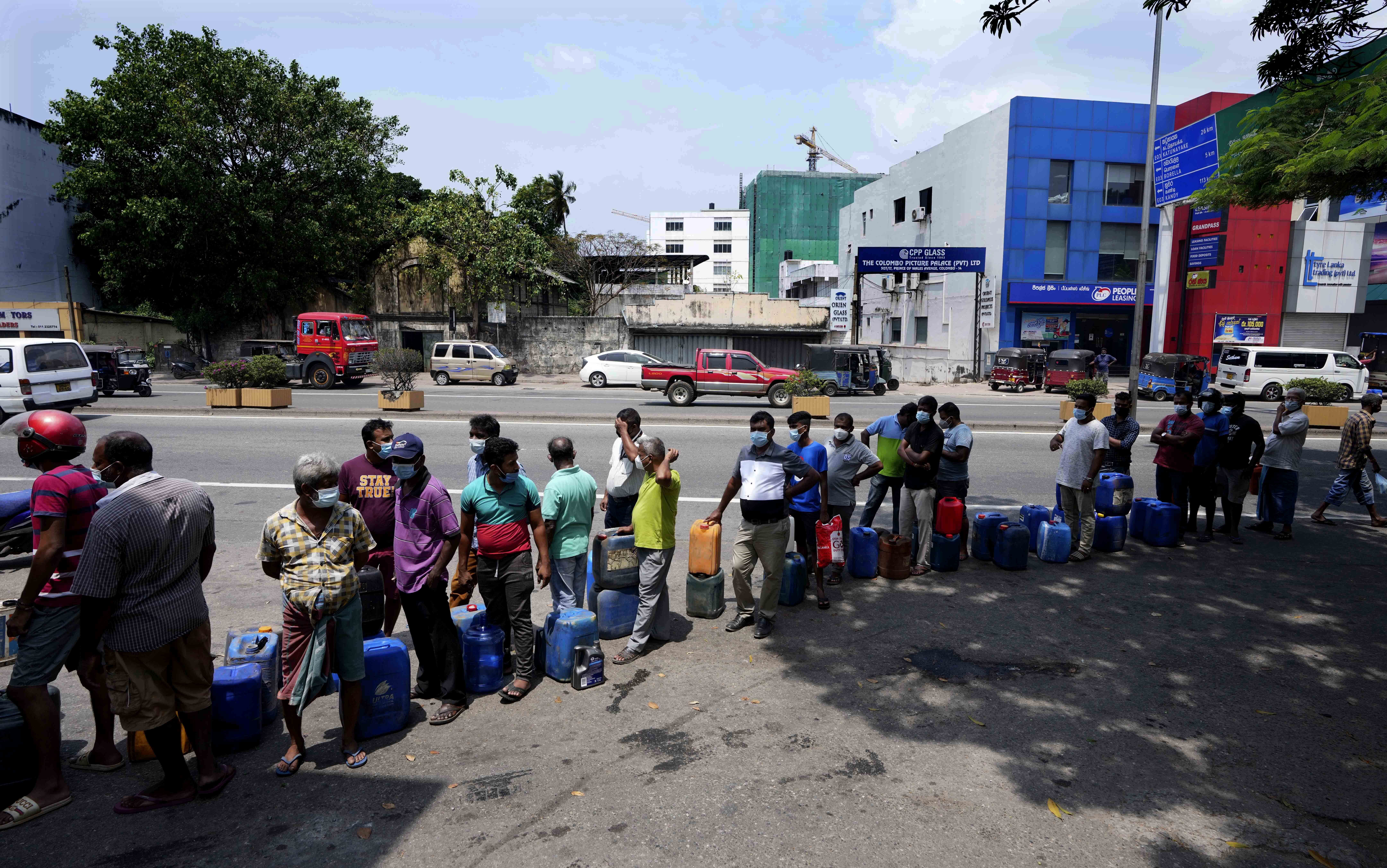 Sri Lankans queue up to buy diesel at a fuel station in Colombo